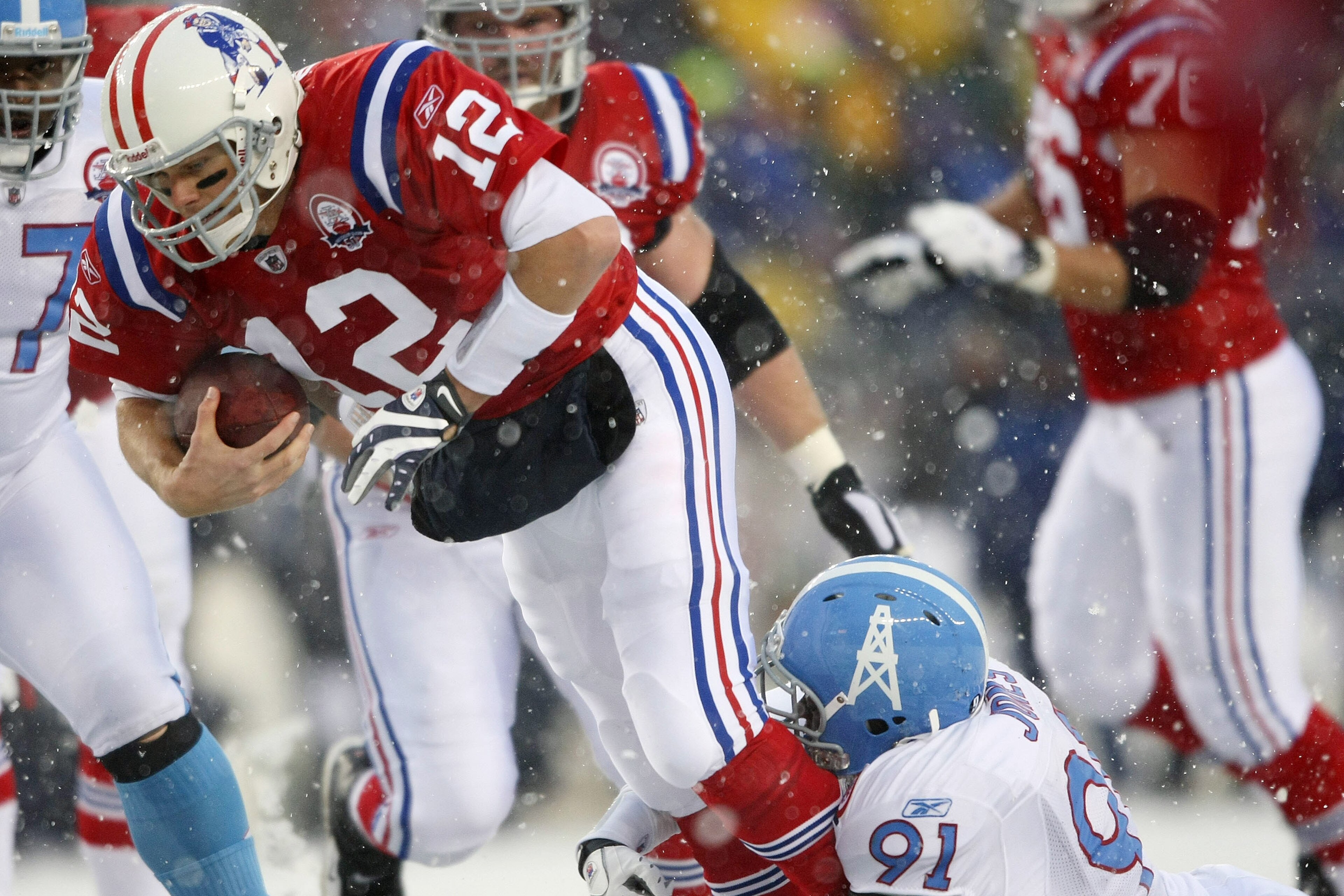 FOXBORO, MA - OCTOBER 18:  Tom Brady #12 of the New England Patriots is sacked by Jason Jones #91 of the Tennessee Titans on October 18, 2009 at Gillette Stadium in Foxboro, Massachusetts.  (Photo by Elsa/Getty Images)