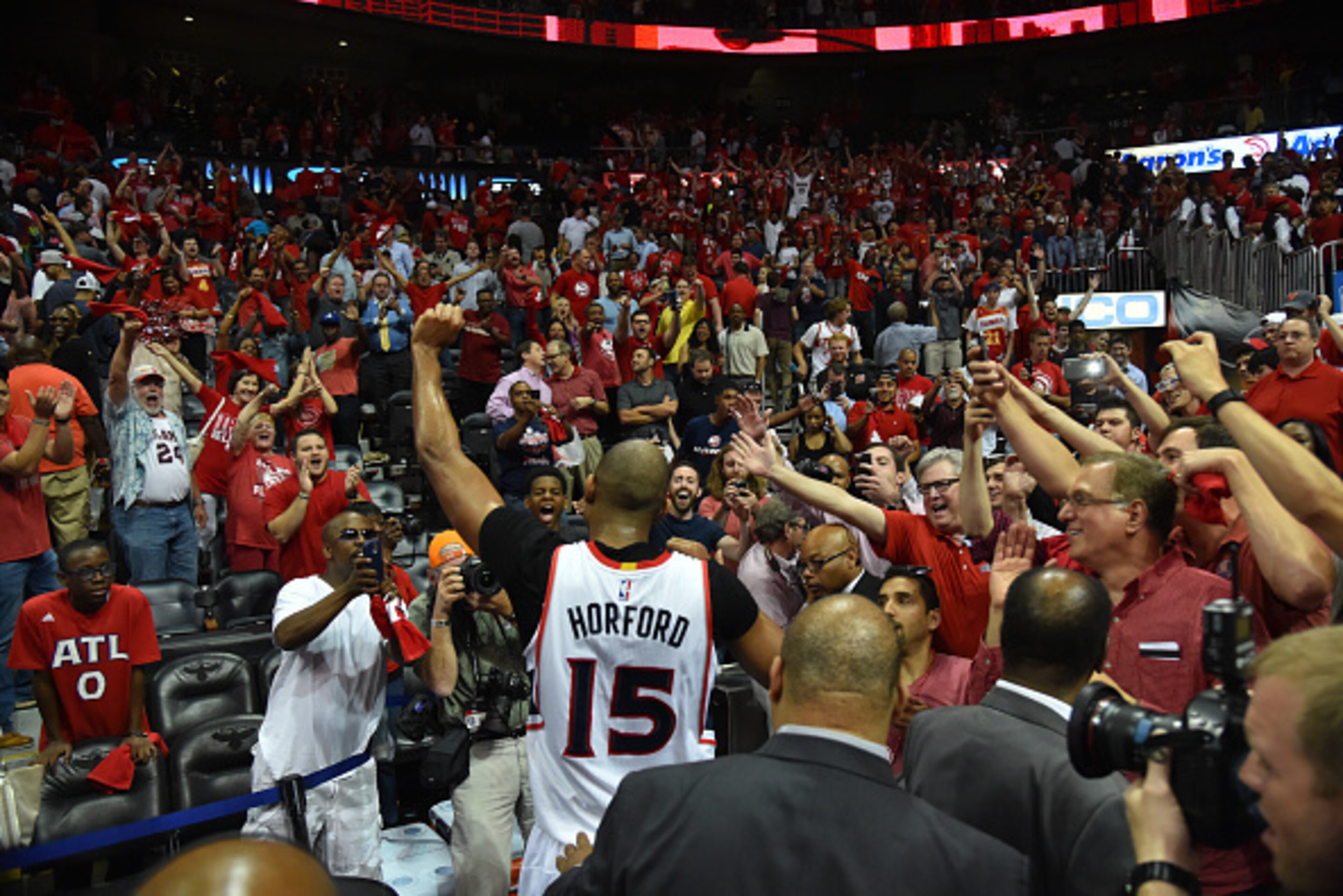 ATLANTA, GA: 	Al Horford #15 of the Atlanta Hawks gives a high five to the fans after hitting the game winning shot against the Washington Wizards in Game five of the Eastern Conference Semifinals of the NBA Playoffs on May 13, 2015 at Philips Arena in At