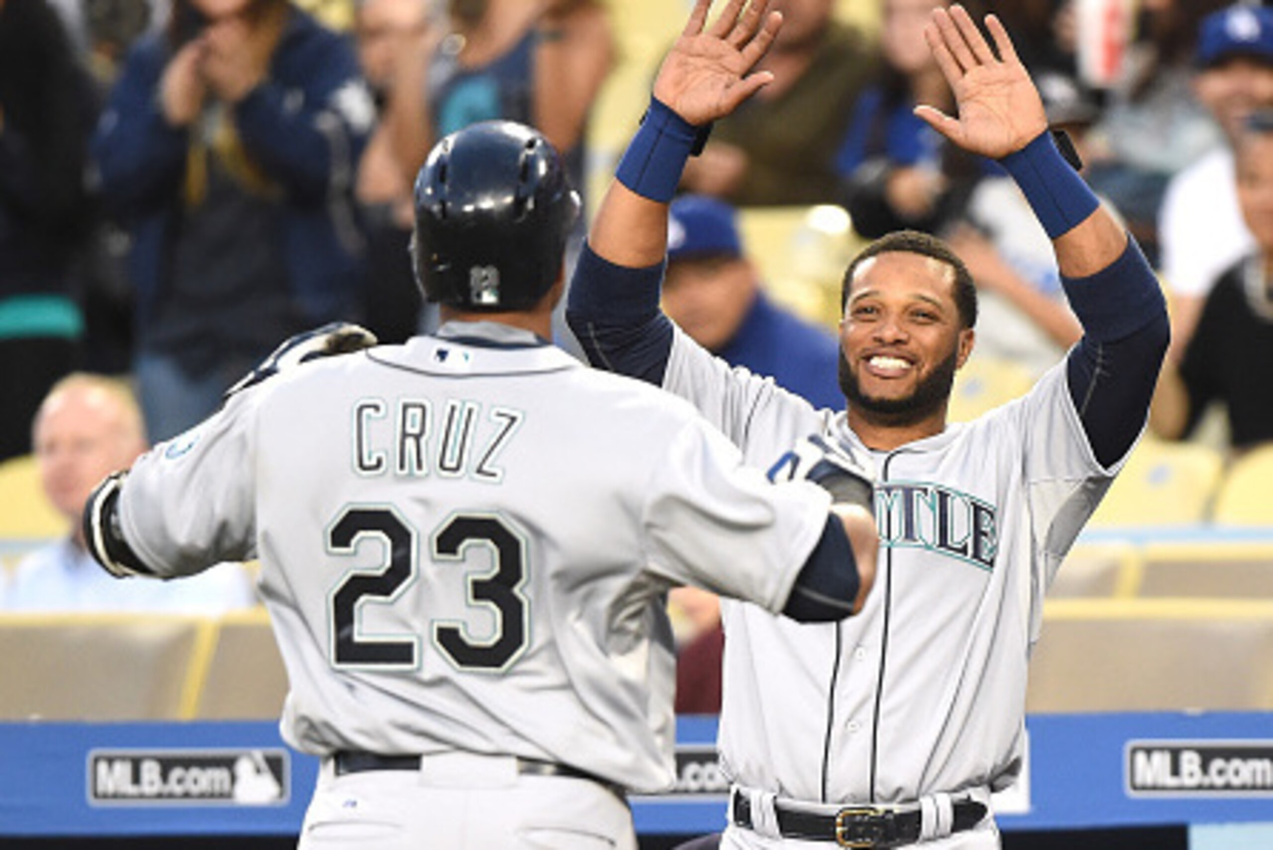 LOS ANGELES, CA - APRIL 14:  Robinson Cano #22 of the Seattle Mariners reacts to a solo homerun from Nelson Cruz #23 of the Seattle Mariners to take a 3-0 lead over the Los Angeles Dodgers during the first inning at Dodger Stadium on April 14, 2015 in Los