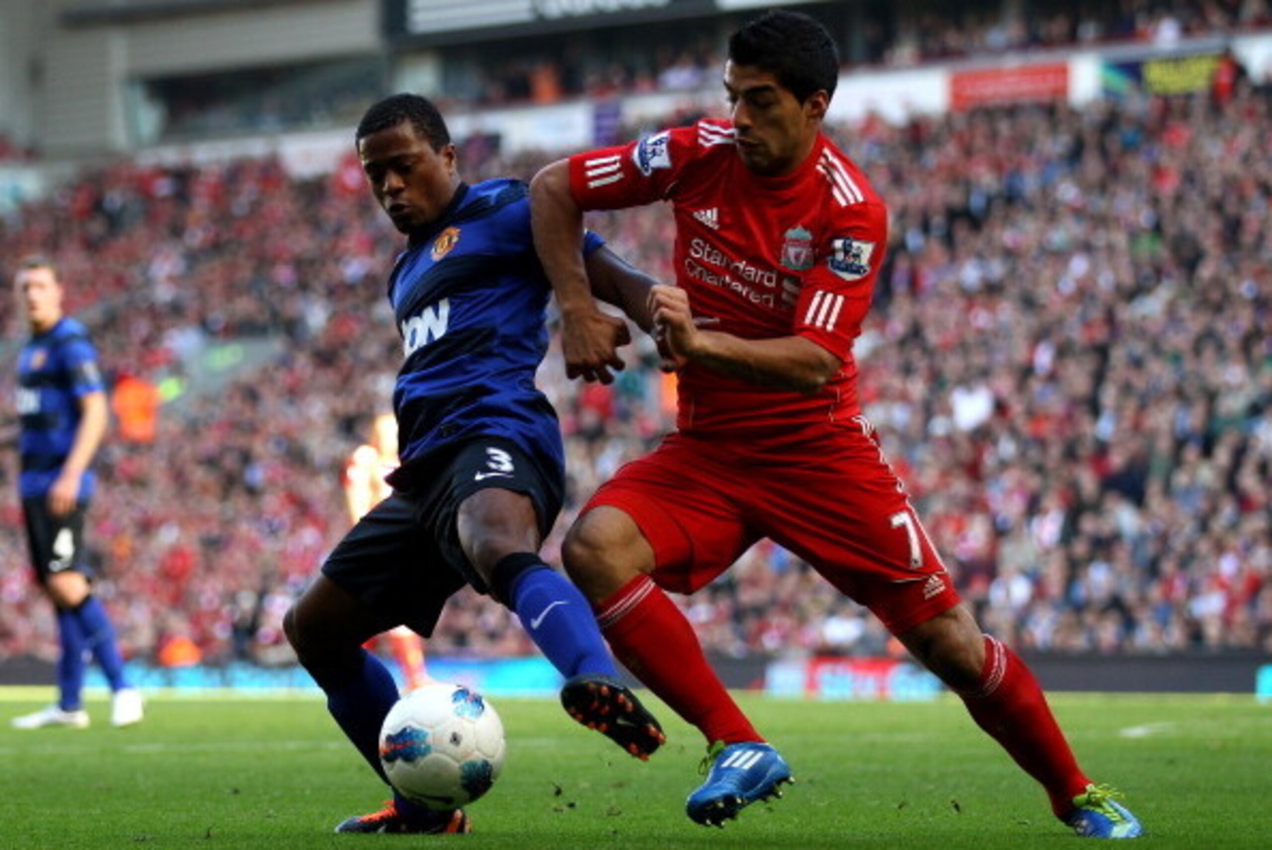 LIVERPOOL, ENGLAND - OCTOBER 15:  Luis Suarez of Liverpool tussles for posesssion with Patrice Evra of Manchester United during the Barclays Premier League match between Liverpool and Manchester United at Anfield on October 15, 2011 in Liverpool, England.