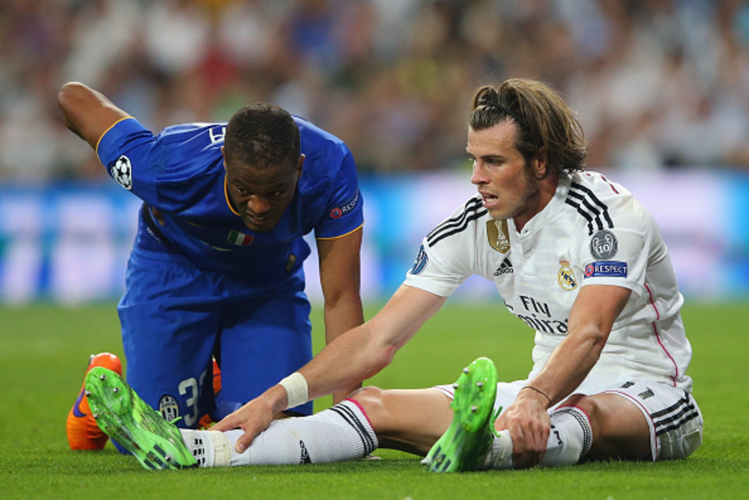 MADRID, SPAIN - MAY 13: Patrice Evra of Juventus and Gareth Bale of Real Madrid react after a collision during the UEFA Champions League Semi Final, second leg match between Real Madrid and Juventus at Estadio Santiago Bernabeu on May 13, 2015 in Madrid, MADRID, SPAIN - MAY 13: Patrice Evra of Juventus and Gareth Bale of Real Madrid react after a collision during the UEFA Champions League Semi Final, second leg match between Real Madrid and Juventus at Estadio Santiago Bernabeu on May 13, 2015 in Madrid,