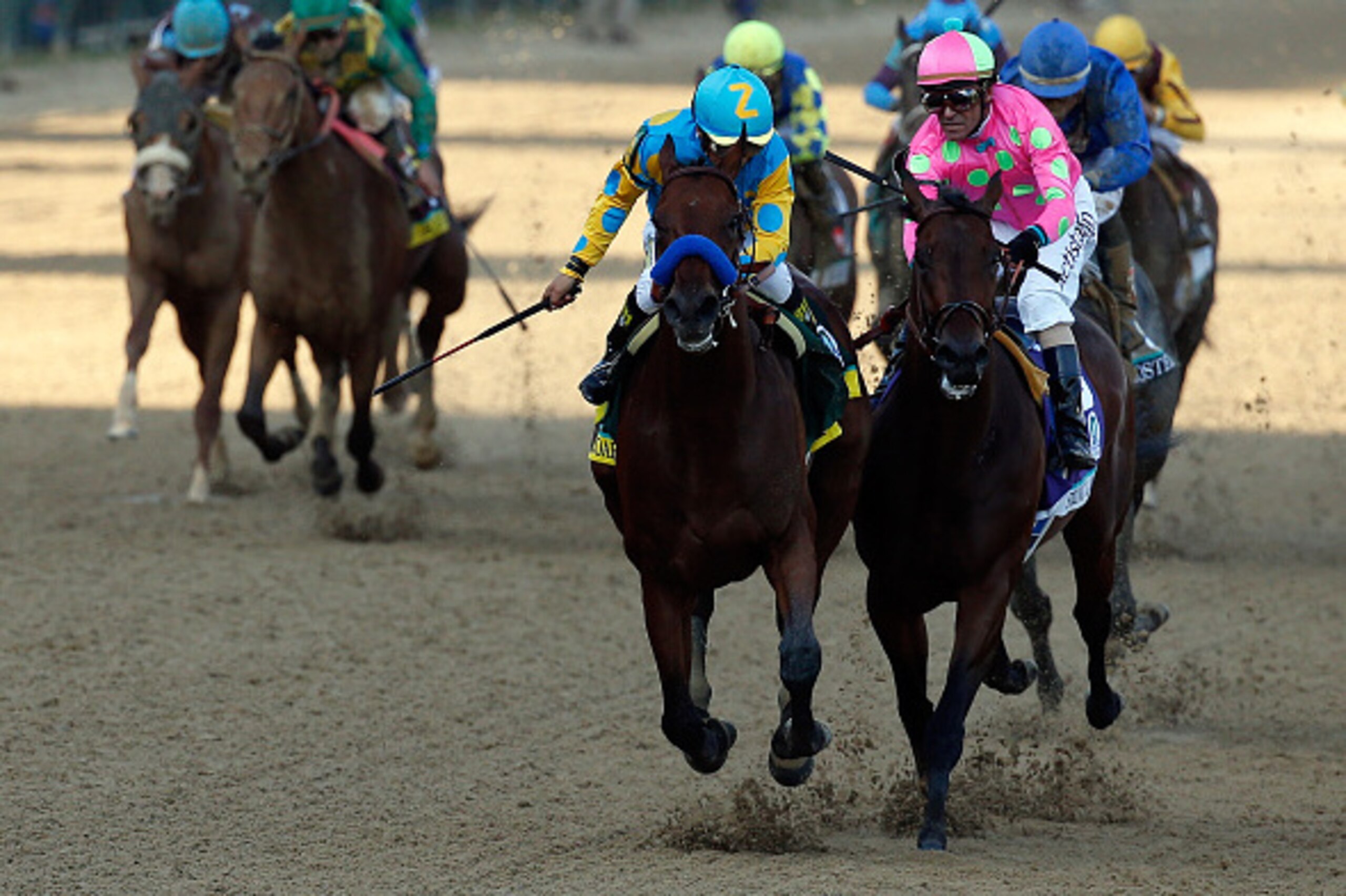 LOUISVILLE, KY - MAY 02:  American Pharoah #18, ridden by Victor Espinoza, races Firing Line #10, ridden by Gary Stevens, down the frontstretch to the finish line during the 141st running of the Kentucky Derby at Churchill Downs on May 2, 2015 in Louisvil