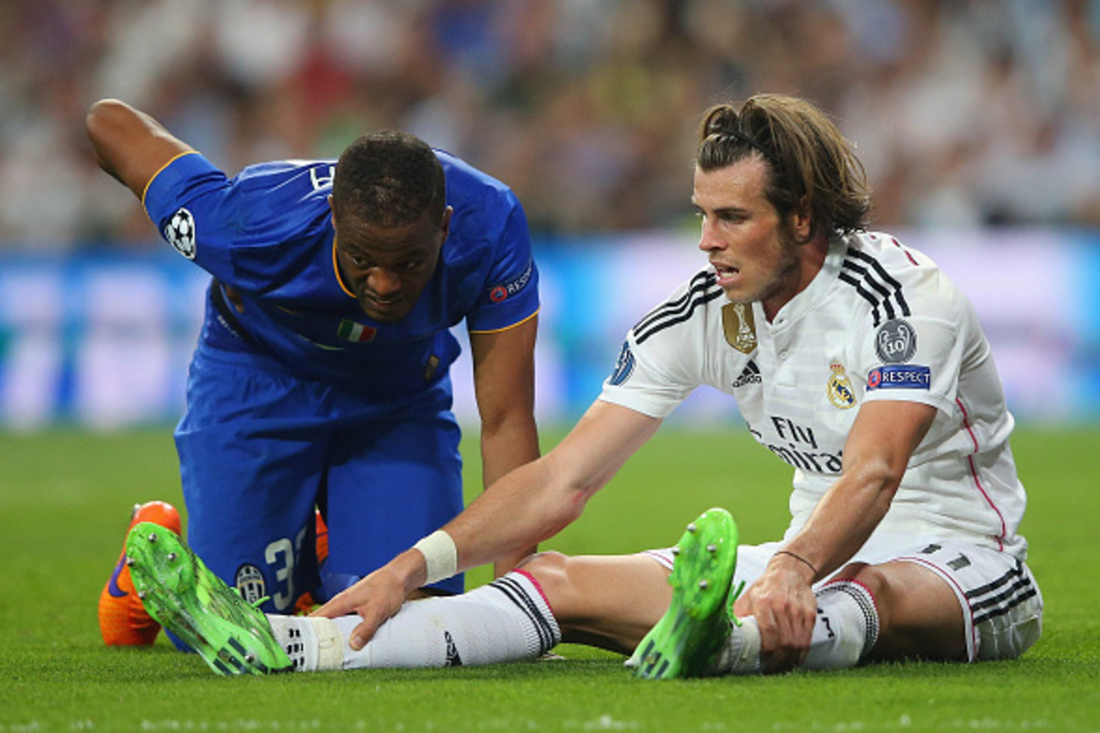 MADRID, SPAIN - MAY 13: Patrice Evra of Juventus and Gareth Bale of Real Madrid react after a collision during the UEFA Champions League Semi Final, second leg match between Real Madrid and Juventus at Estadio Santiago Bernabeu on May 13, 2015 in Madrid, MADRID, SPAIN - MAY 13: Patrice Evra of Juventus and Gareth Bale of Real Madrid react after a collision during the UEFA Champions League Semi Final, second leg match between Real Madrid and Juventus at Estadio Santiago Bernabeu on May 13, 2015 in Madrid,