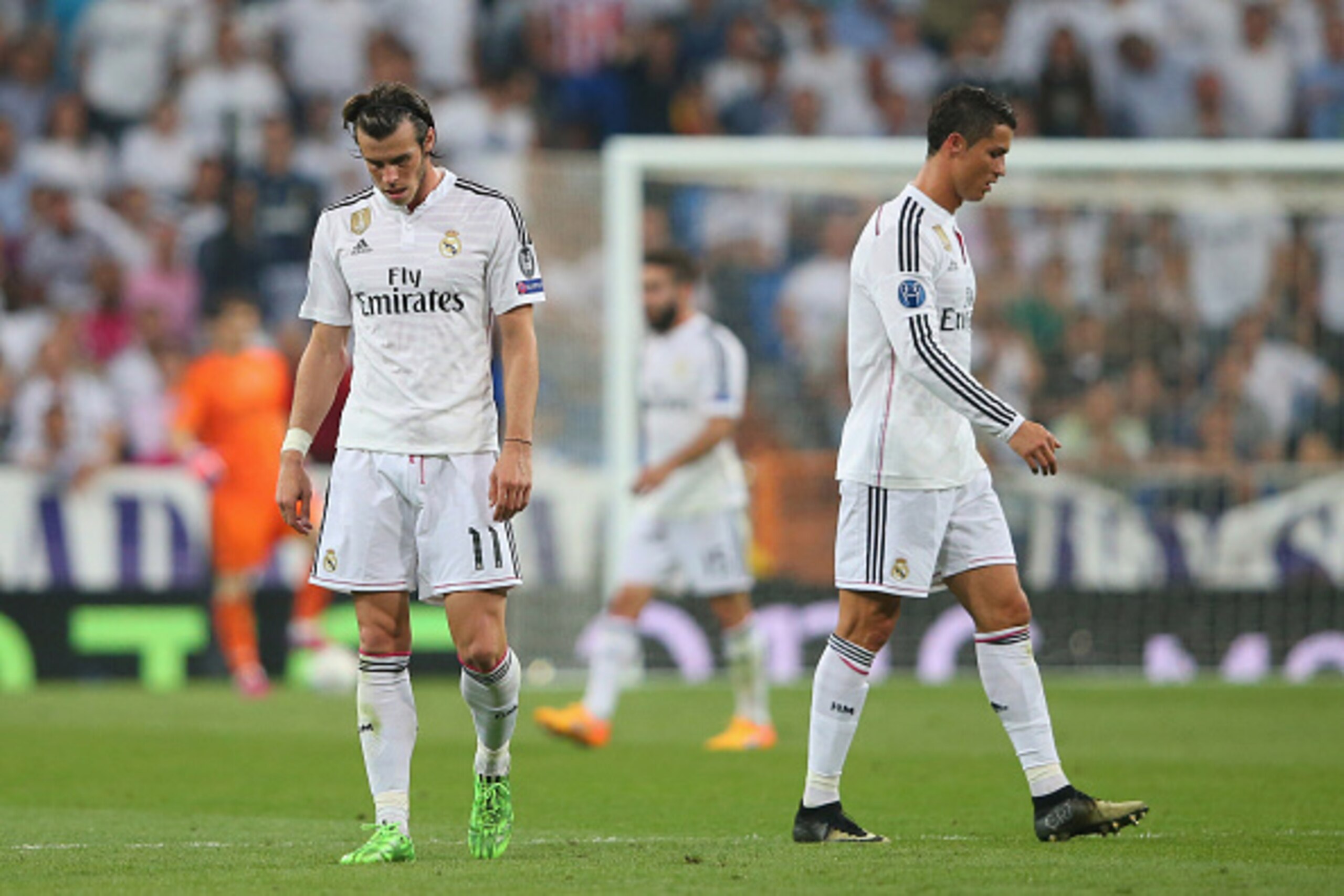 MADRID, SPAIN - MAY 13:  (L-R) Dejected Real Madrid teammates Gareth Bale and Cristiano Ronaldo walk off the pitch following their team's exit from the competition during the UEFA Champions League Semi Final, second leg match between Real Madrid and Juven