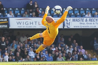 PORTSMOUTH, ENGLAND - APRIL 18: Goalkeeper Brad Friedel of Aston Villa makes a diving save during the Barclays Premier League match between Portsmouth and Aston Villa at Fratton Park on April 18, 2010 in Portsmouth, England.  (Photo by Phil Cole/Getty Ima