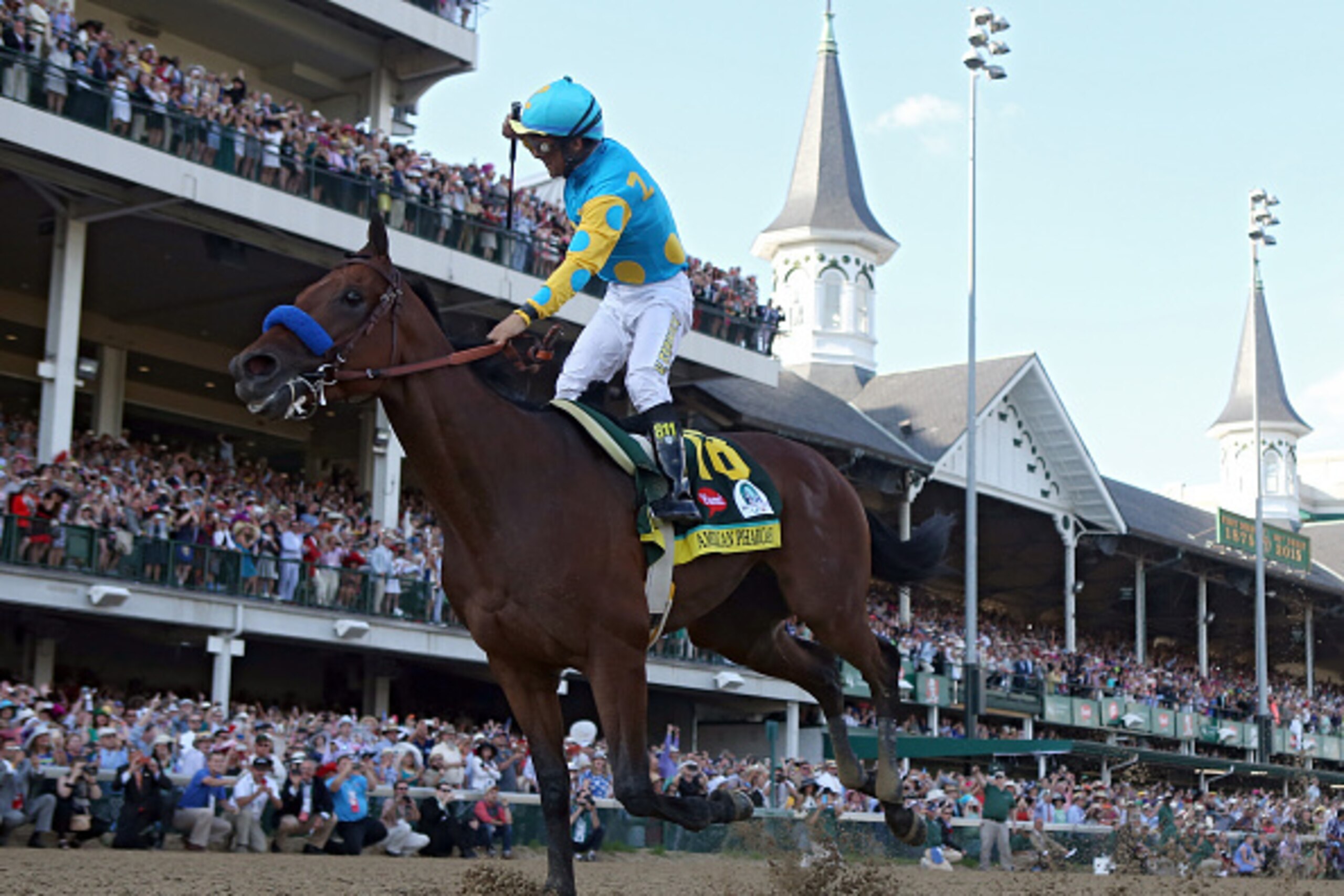 LOUISVILLE, KY - MAY 02:  Jockey Victor Espinoza celebrates as he guides American Pharoah #18 after crossing the finish line to win the 141st running of the Kentucky Derby at Churchill Downs on May 2, 2015 in Louisville, Kentucky.  (Photo by Rob Carr/Gett
