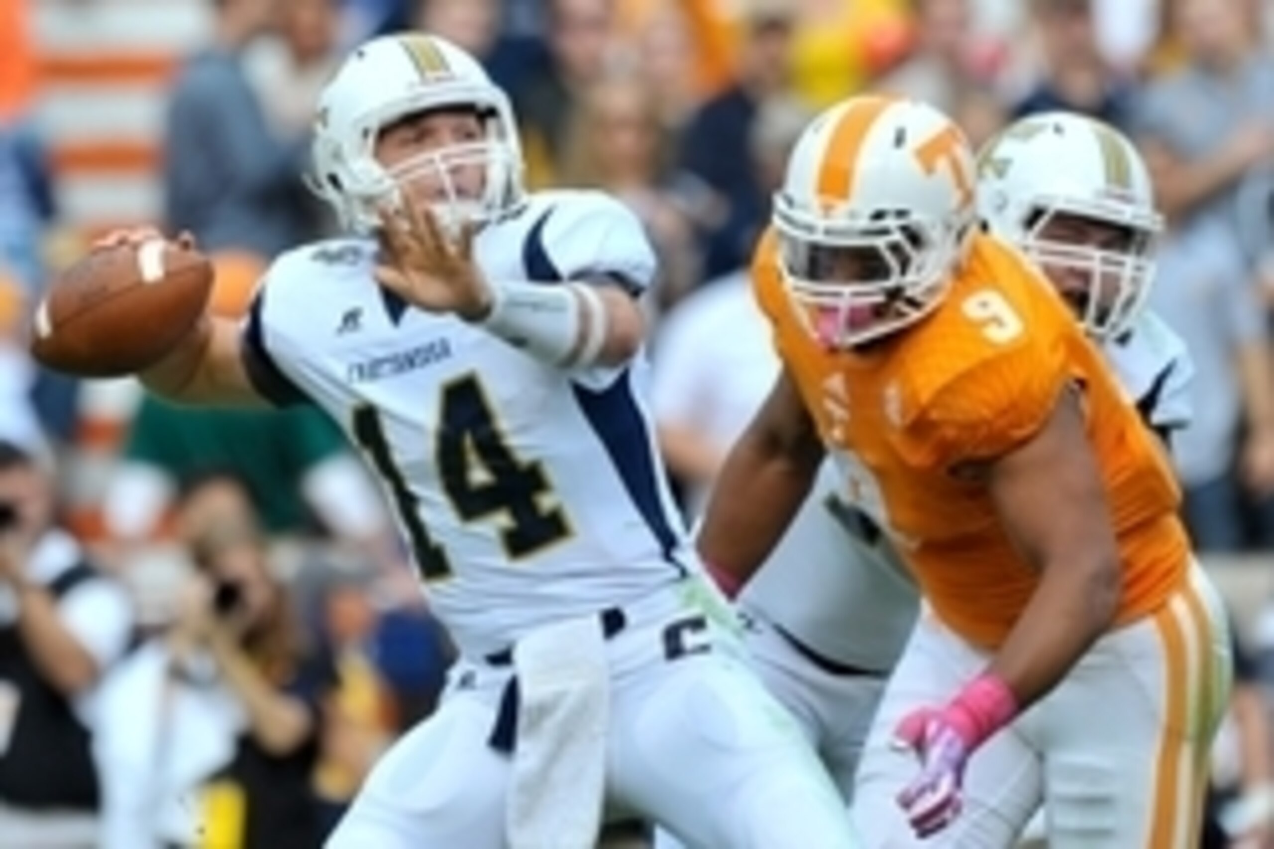 Oct 11, 2014; Knoxville, TN, USA; Tennessee Volunteers defensive end Derek Barnett (9) rushes in for the sack on Chattanooga Mocs quarterback Jacob Huesman (14) during the first half at Neyland Stadium. Mandatory Credit: Jim Brown-USA TODAY Sports