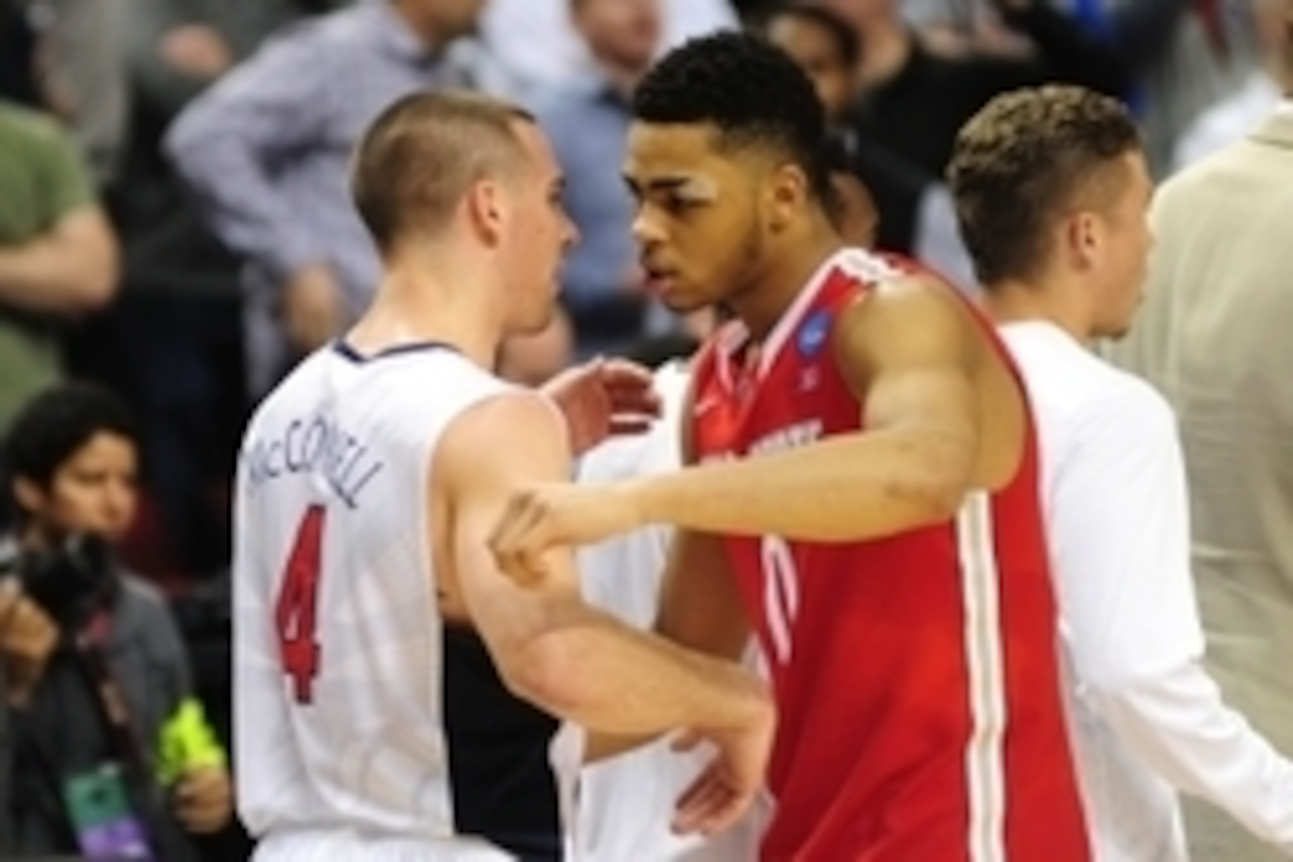 Mar 21, 2015; Portland, OR, USA; Arizona Wildcats guard T.J. McConnell (4) is congratulated by Ohio State Buckeyes guard D'Angelo Russell (0) after the game in the third round of the 2015 NCAA Tournament at Moda Center. The Wildcats defeated the Buckeyes 