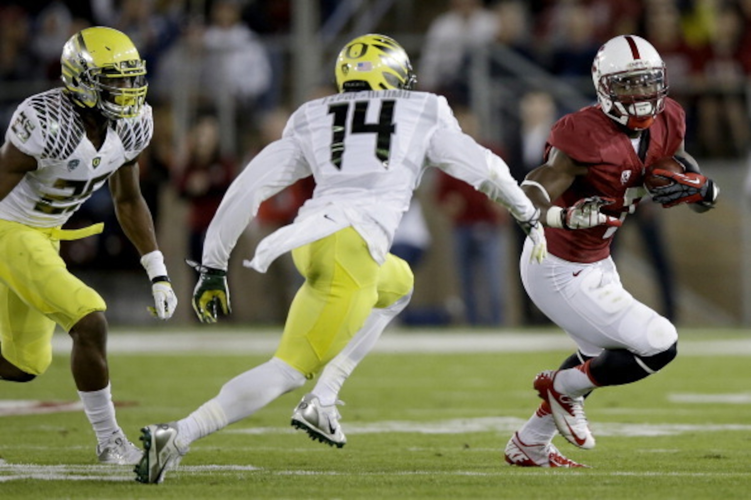 PALO ALTO, CA - NOVEMBER 07:  Wide receiver Ty Montgomery #7 of the Stanford Cardinal with the ball against cornerback Ifo Ekpre-Olomu #14 of the Oregon Ducks in the first half at Stanford Stadium on November 7, 2013 in Palo Alto, California.  (Photo by E