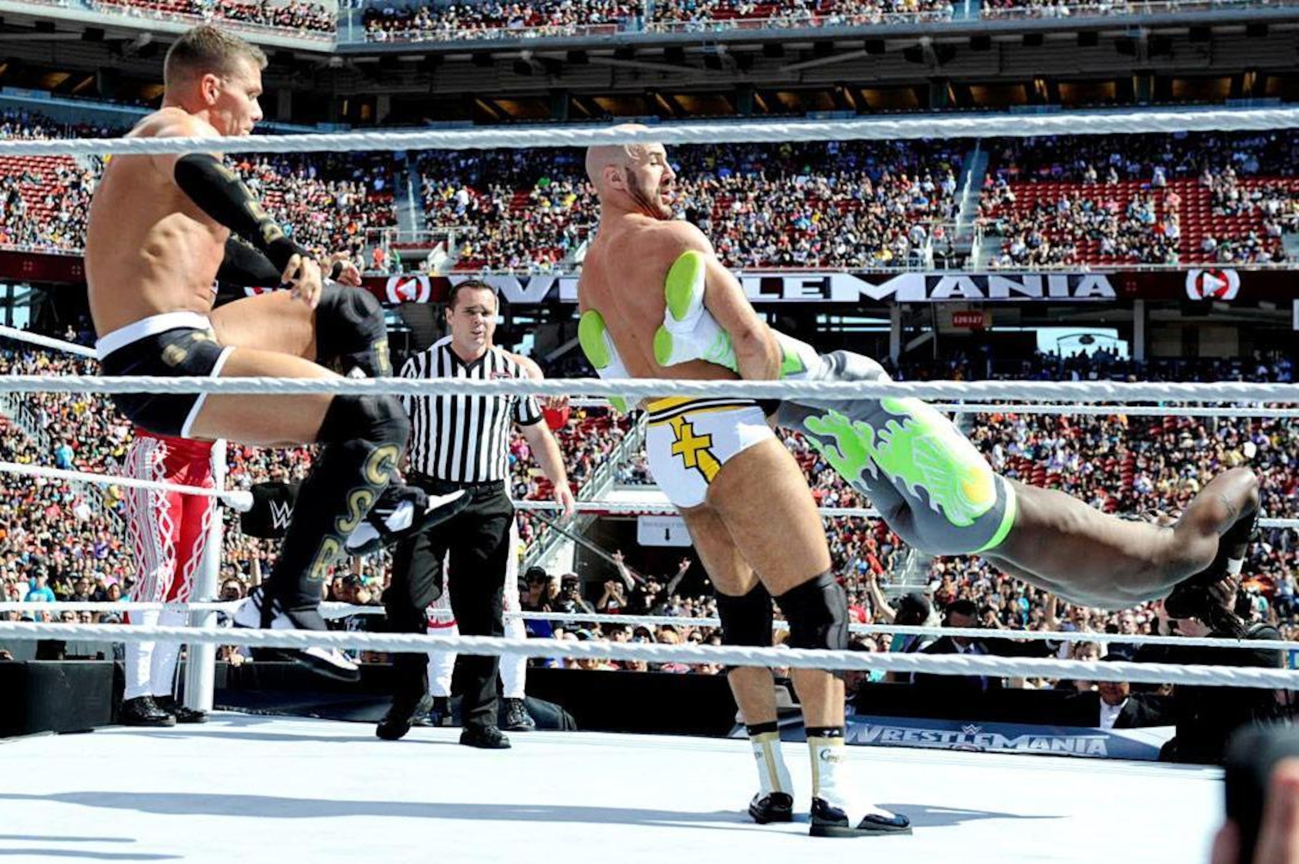 Tyson Kidd and Cesaro team up on Kofi Kingston.