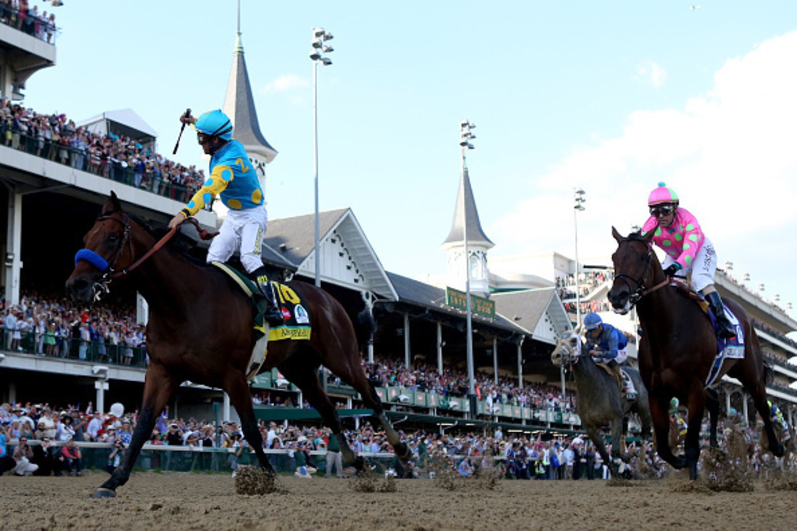 LOUISVILLE, KY - MAY 02: Jockey Victor Espinoza celebrates as he guides American Pharoah #18 ahead of Firing Line #10, ridden by Gary Stevens, after crossing the finish line to win the 141st running of the Kentucky Derby at Churchill Downs on May 2, 2015 LOUISVILLE, KY - MAY 02: Jockey Victor Espinoza celebrates as he guides American Pharoah #18 ahead of Firing Line #10, ridden by Gary Stevens, after crossing the finish line to win the 141st running of the Kentucky Derby at Churchill Downs on May 2, 2015
