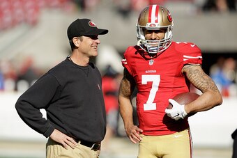 SANTA CLARA, CA - DECEMBER 28:  Head coach Jim Harbaugh of the San Francisco 49ers talks with Colin Kaepernick #7 before their game against the Arizona Cardinals at Levi's Stadium on December 28, 2014 in Santa Clara, California.  (Photo by Ezra Shaw/Getty