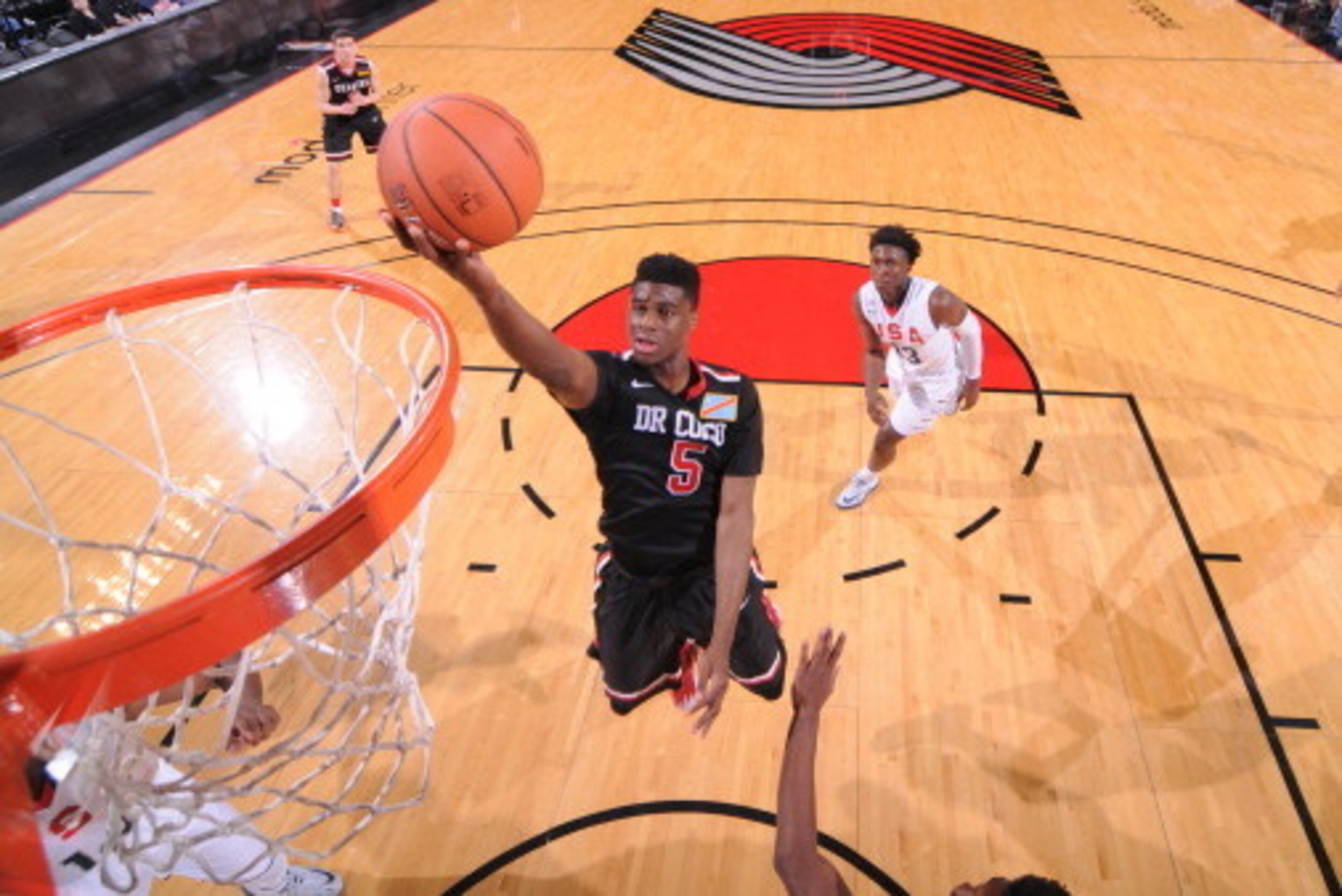 PORTLAND, OR - APRIL 12: Emmanuel Mudiay #5 of the World Team drives to the basket against the USA Team on April 12, 2014 at the Moda Center Arena in Portland, Oregon. NOTE TO USER: User expressly acknowledges and agrees that, by downloading and or using PORTLAND, OR - APRIL 12: Emmanuel Mudiay #5 of the World Team drives to the basket against the USA Team on April 12, 2014 at the Moda Center Arena in Portland, Oregon. NOTE TO USER: User expressly acknowledges and agrees that, by downloading and or using