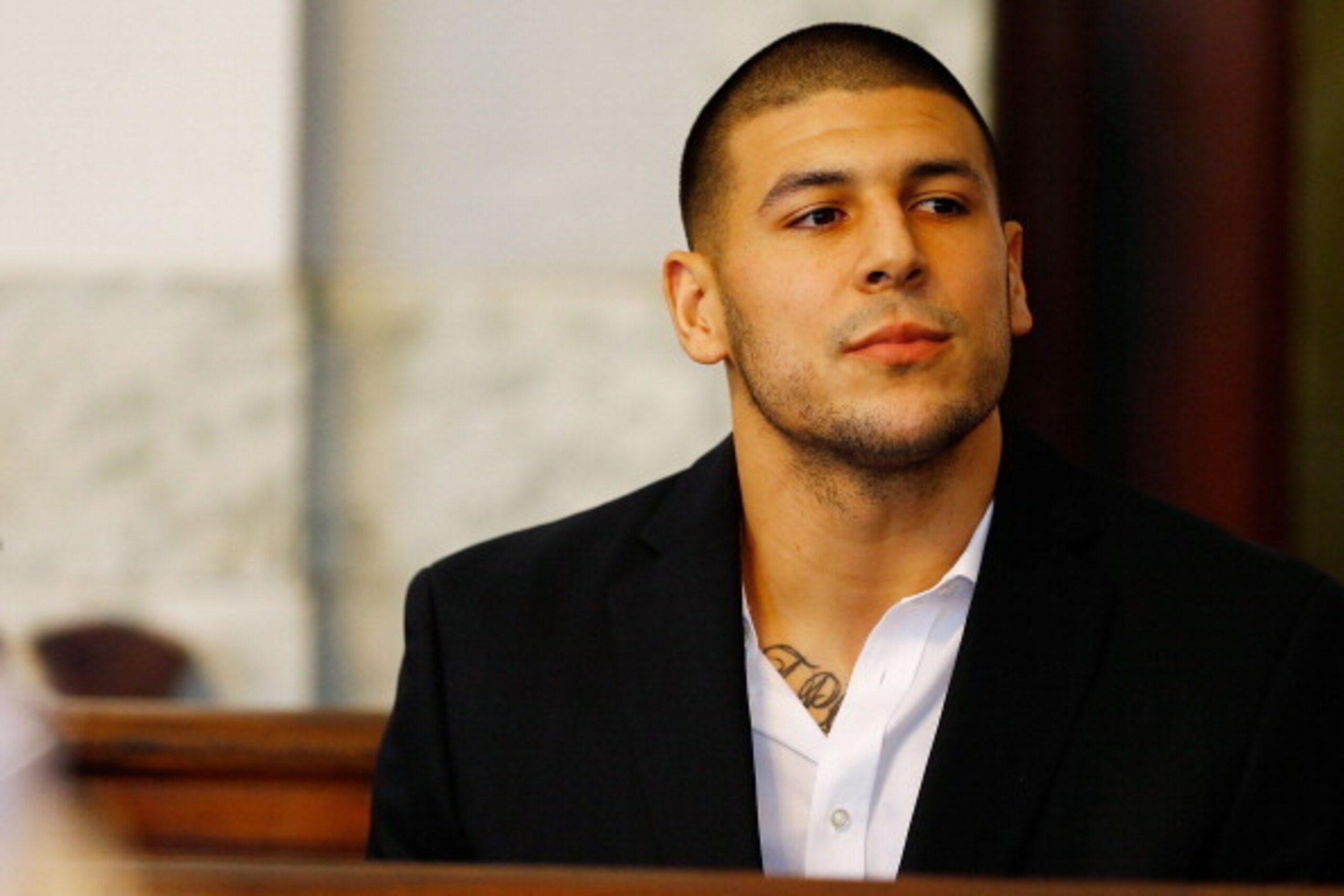 NORTH ATTLEBORO, MA - AUGUST 22: Aaron Hernandez sits in the courtroom of the Attleboro District Court during his hearing on August 22, 2013 in North Attleboro, Massachusetts. Former New England Patriot Aaron Hernandez has been indicted on a first-degree 