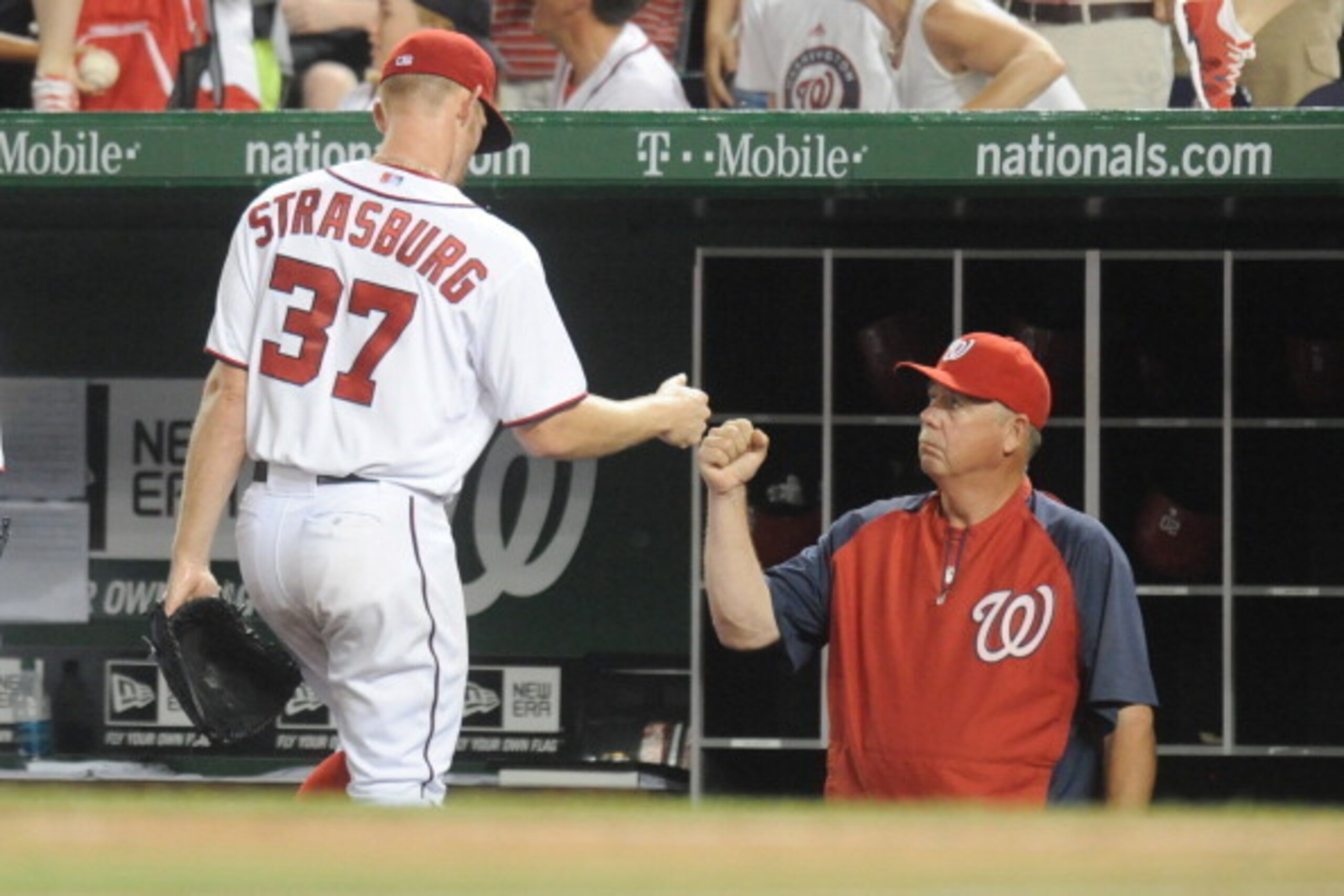 WASHINGTON, DC - JULY 1:  Pitching coach Steve McCatty #54 of the Washington Nationals congratulates Stephen Strasburg #37 after the sixth inning during a baseball against the Colorado Rockies on July 1, 2014 at Nationals Park in Washington, DC.  (Photo b