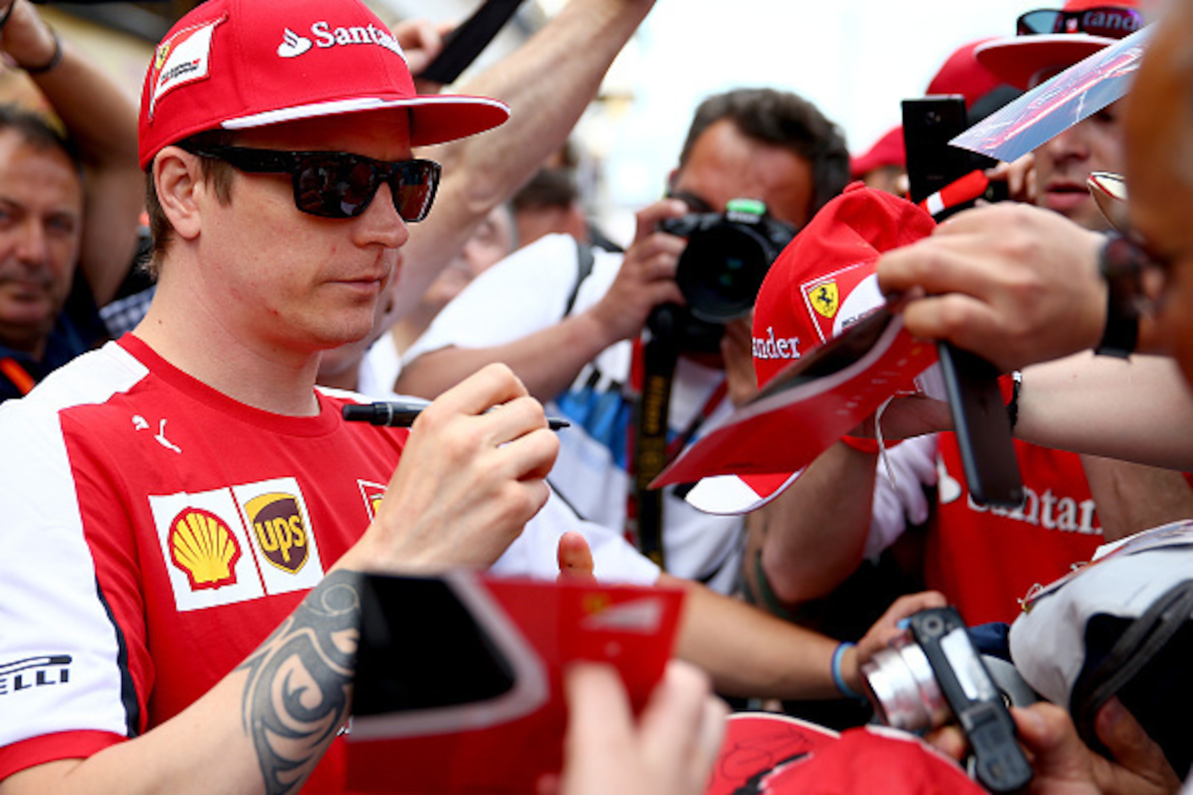 MONTMELO, SPAIN - MAY 07: Kimi Raikkonen of Finland and Ferrari signs autographs for fans in the pit lane during previews to the Spanish Formula One Grand Prix at Circuit de Catalunya on May 7, 2015 in Montmelo, Spain. (Photo by Clive Mason/Getty Images MONTMELO, SPAIN - MAY 07: Kimi Raikkonen of Finland and Ferrari signs autographs for fans in the pit lane during previews to the Spanish Formula One Grand Prix at Circuit de Catalunya on May 7, 2015 in Montmelo, Spain. (Photo by Clive Mason/Getty Images