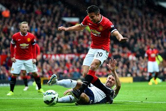 MANCHESTER, ENGLAND - MAY 02:  Robin van Persie of Manchester United shoots at goal under pressure from Gareth McAuley of West Brom during the Barclays Premier League match between Manchester United and West Bromwich Albion at Old Trafford on May 2, 2015 