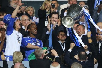 MUNICH, GERMANY - MAY 19:  Club owner Roman Abramovich (R) lifts the trophy in celebration while  Chancellor of the Exchequer George Osborne (C) applauds after their victory in the UEFA Champions League Final between FC Bayern Muenchen and Chelsea at the 