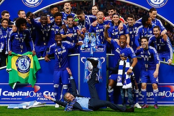 LONDON, ENGLAND - MARCH 01:  (EDITORS NOTE: ALTERNATIVE CROP OF IMAGE NUMBER #464882182) Manager Jose Mourinho of Chelsea lies on the pitch as Chelsea celebrate with the trophy during the Capital One Cup Final match between Chelsea and Tottenham Hotspur a
