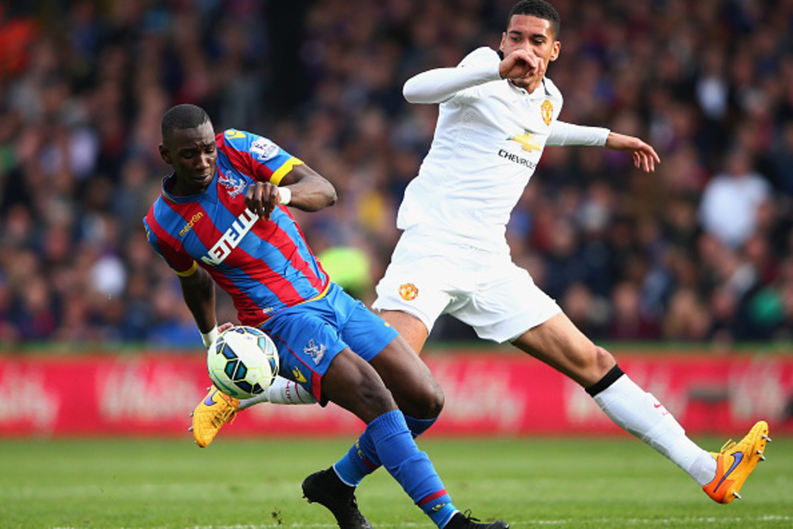 LONDON, ENGLAND - MAY 09: Yannick Bolasie of Crystal Palace is challenged by Chris Smalling of Manchester United during the Barclays Premier League match between Crystal Palace and Manchester United at Selhurst Park on May 9, 2015 in London, England. (P LONDON, ENGLAND - MAY 09: Yannick Bolasie of Crystal Palace is challenged by Chris Smalling of Manchester United during the Barclays Premier League match between Crystal Palace and Manchester United at Selhurst Park on May 9, 2015 in London, England. (P