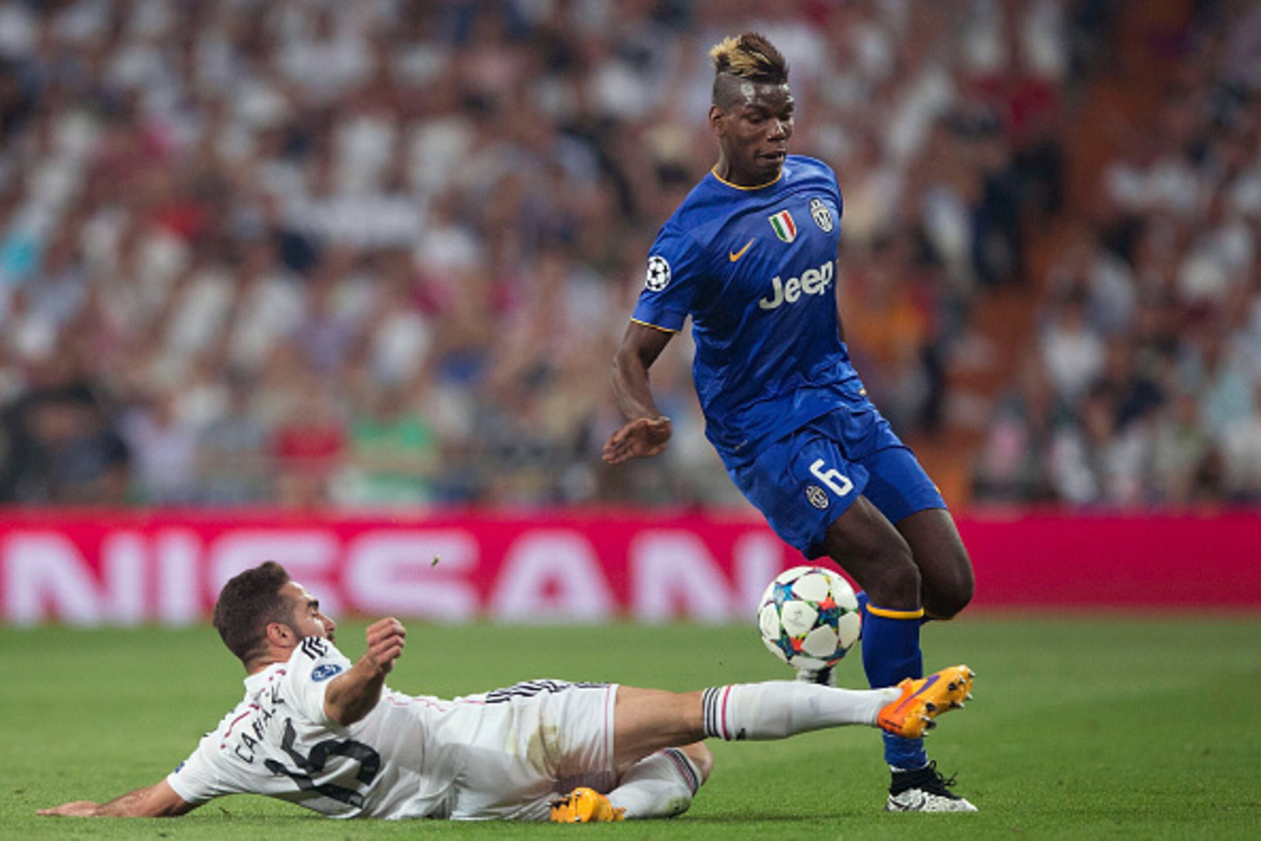 MADRID, SPAIN - MAY 13:  Paul Pogba of Juventus is tackled  by Daniel Carvajal of Real Madrid during the UEFA Champions League Semi Final, second leg match between Real Madrid and Juventus at Estadio Santiago Bernabeu on May 13, 2015 in Madrid, Spain.  (P