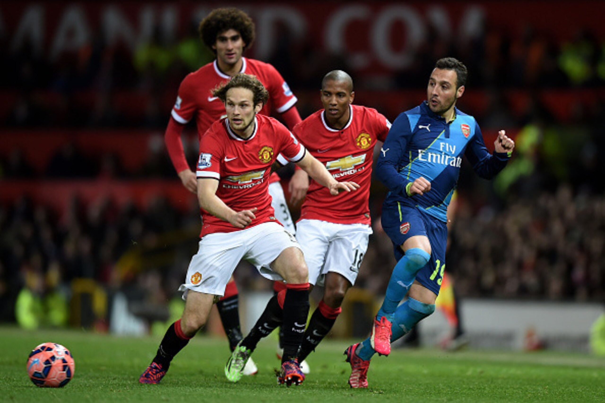MANCHESTER, ENGLAND - MARCH 09:  Santi Cazorla of Arsenal is closed down by Daley Blind (L), Marouane Fellaini (2nd L) and Ashley Young (3rd L) of Manchester United during the FA Cup Quarter Final match between Manchester United and Arsenal at Old Traffor