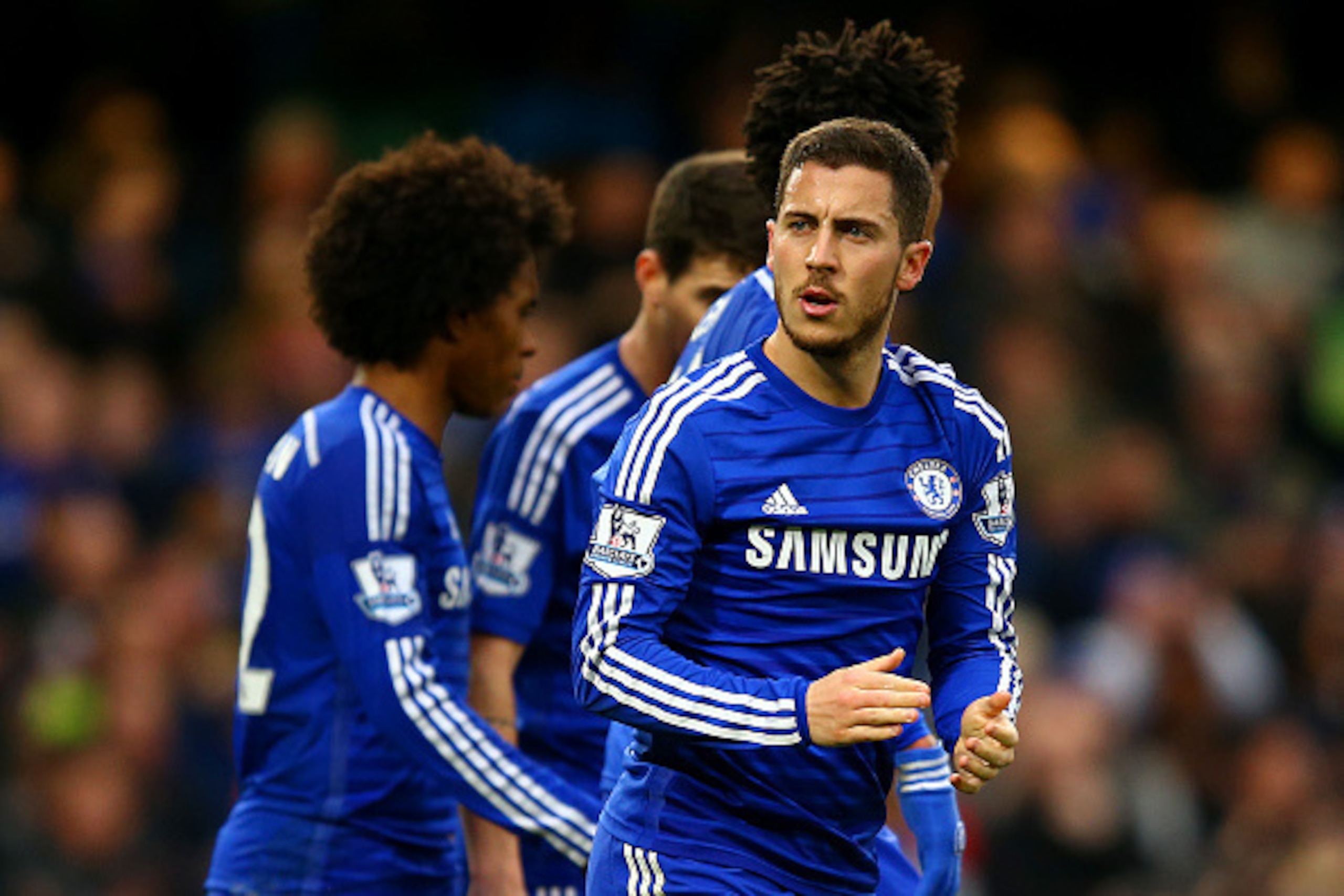 LONDON, ENGLAND - APRIL 04:  Eden Hazard of Chelsea celebrates with team-mates after scoring the opening goal from the penalty spot during the Barclays Premier League match between Chelsea and Stoke City at Stamford Bridge on April 4, 2015 in London, Engl