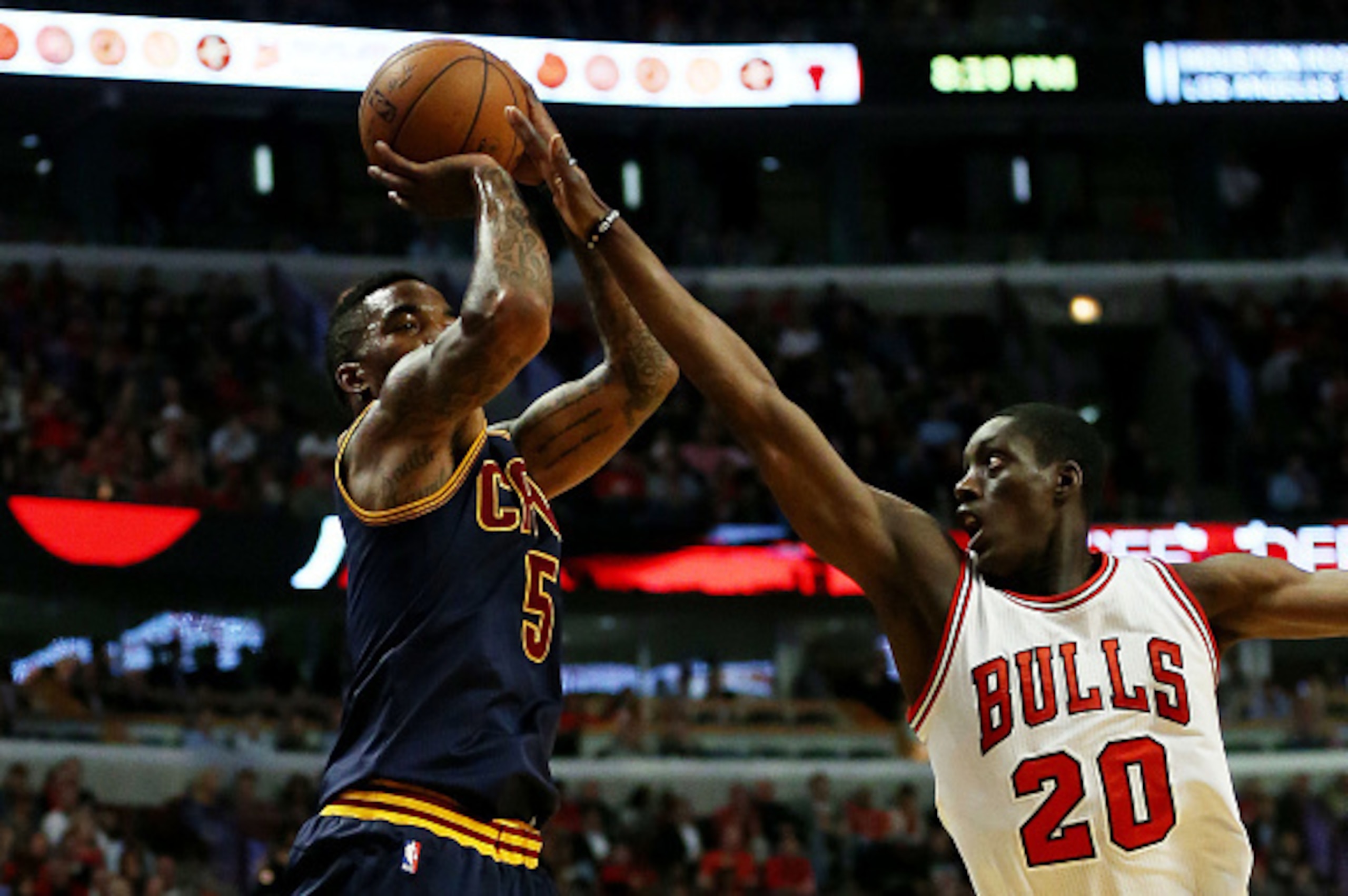 CHICAGO, IL - MAY 14:  J.R. Smith #5 of the Cleveland Cavaliers shoots against Tony Snell #20 of the Chicago Bulls in the second quarter during Game Six of the Eastern Conference Semifinals of the 2015 NBA Playoffs at United Center on May 14, 2015 in Chic