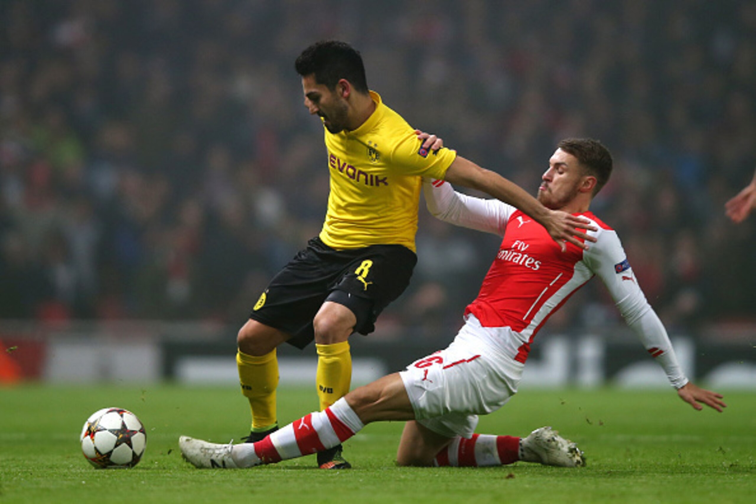 LONDON, ENGLAND - NOVEMBER 26:  Ilkay Gundogan of Borussia Dortmund is tackled by Aaron Ramsey of Arsenal during the UEFA Champions League Group D match between Arsenal and Borussia Dortmund at the Emirates Stadium on November 26, 2014 in London, United K