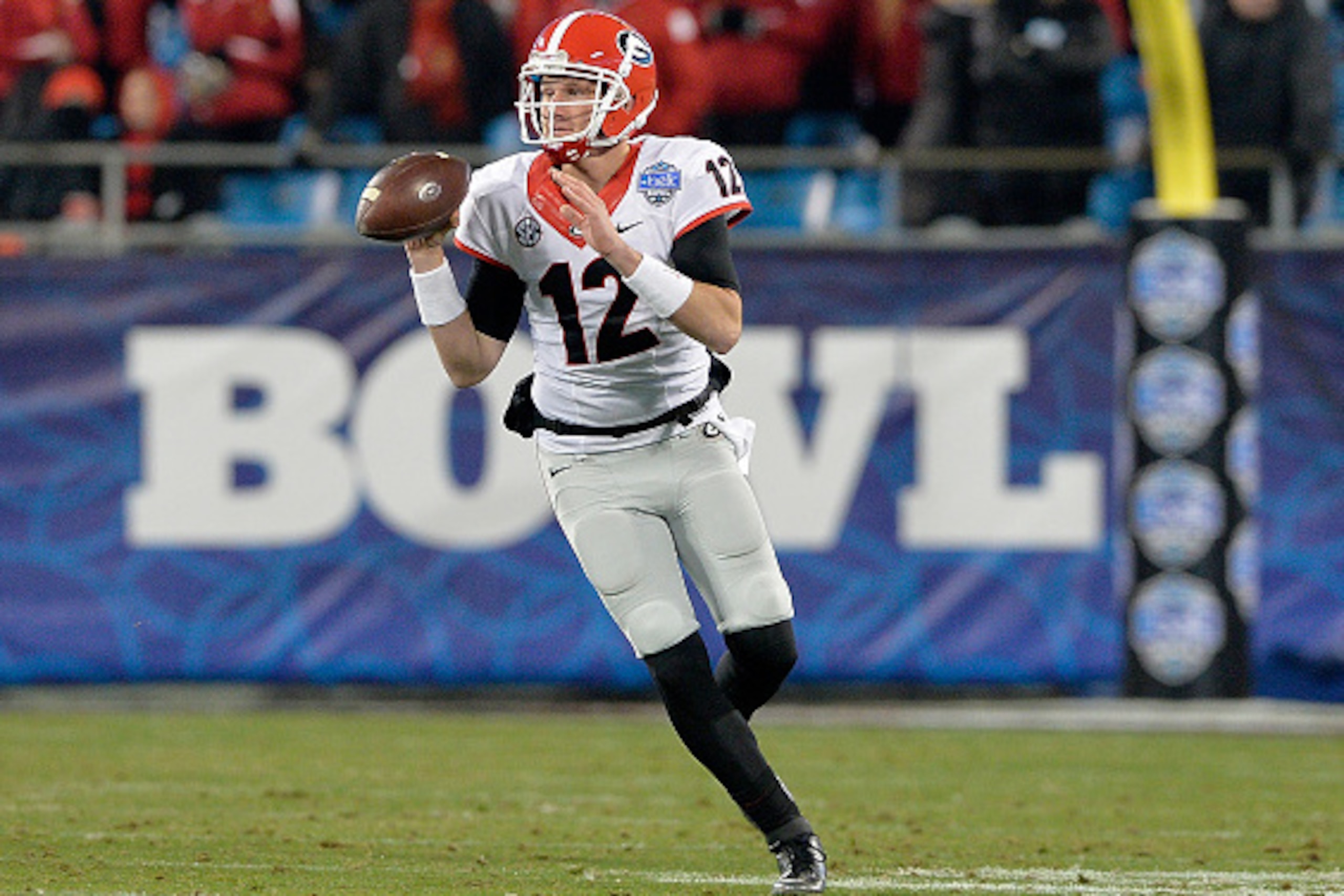 CHARLOTTE, NC - DECEMBER 30:  Brice Ramsey #12 of the Georgia Bulldogs rolls out against the Louisville Cardinals during the Belk Bowl at Bank of America Stadium on December 30, 2014 in Charlotte, North Carolina. Georgia won 37-14.  (Photo by Grant Halver