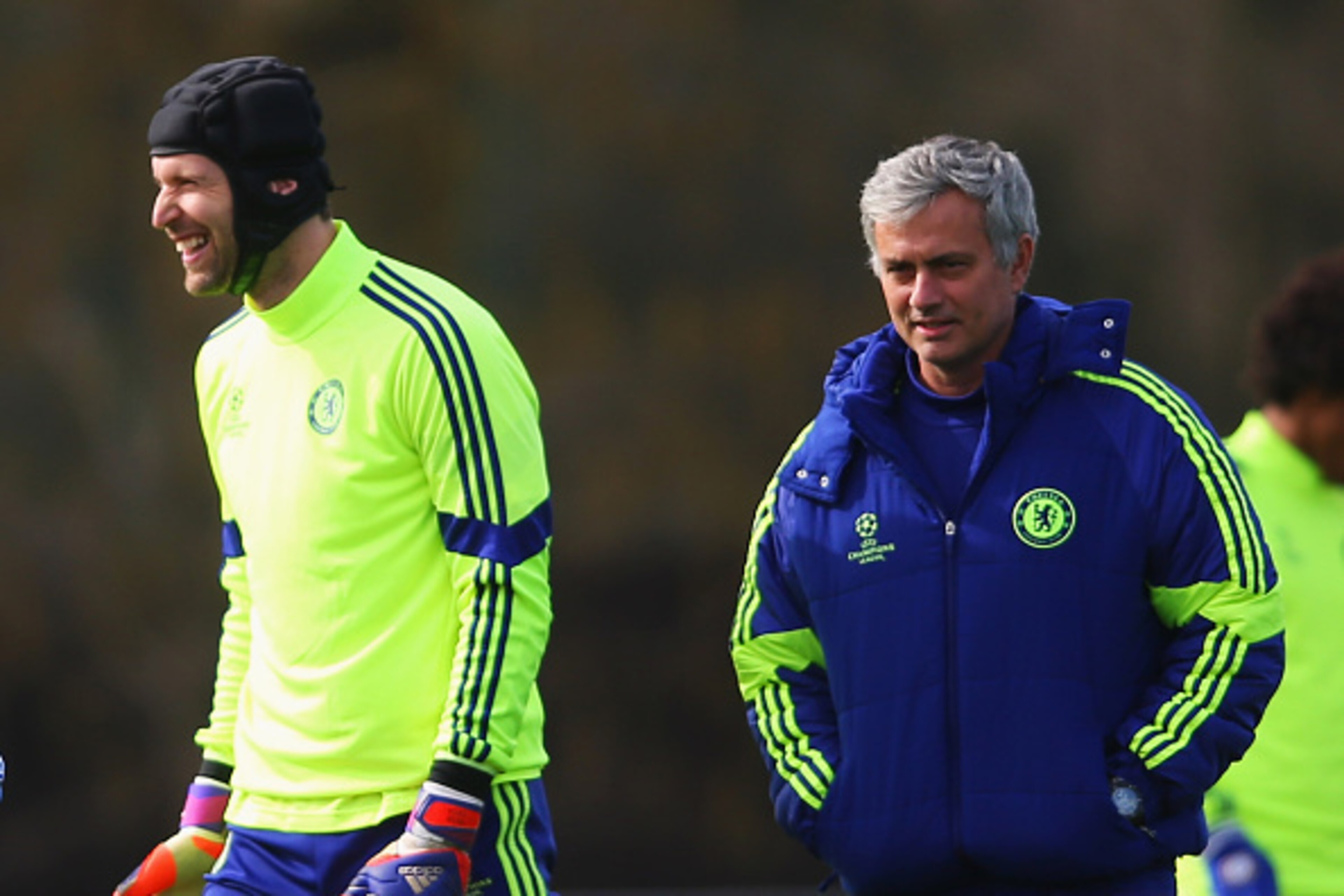 COBHAM, ENGLAND - MARCH 10:  Jose Mourinho manager of Chelsea (R) and goalkeeper Petr Cech (2R) smile during a Chelsea training session ahead of the UEFA Champions League Round of 16 second leg match against Paris Saint-Germain at Chelsea Training Ground 