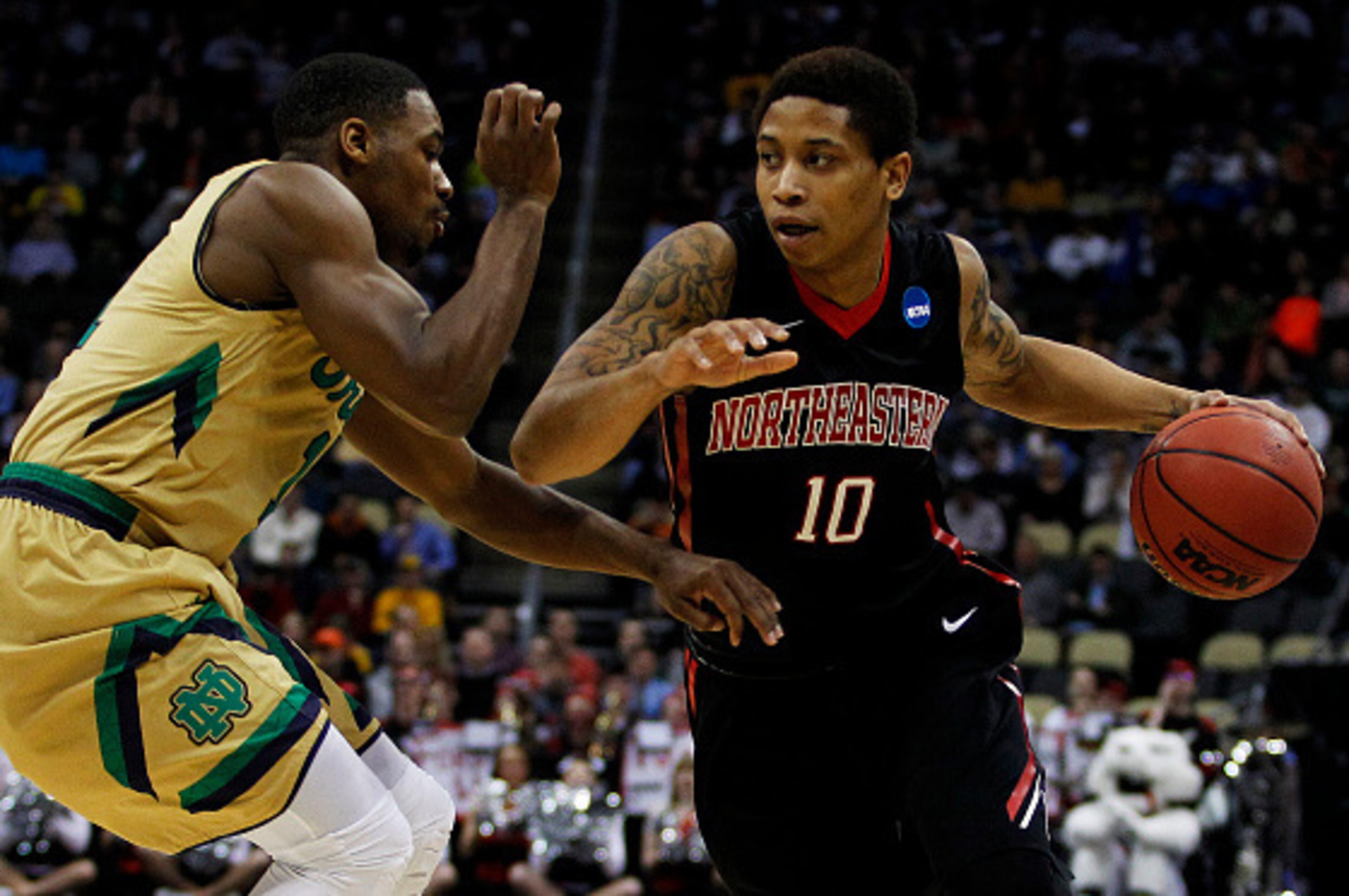 PITTSBURGH, PA - MARCH 19:  T.J. Williams #10 of the Northeastern Huskies drives against Demetrius Jackson #11 of the Notre Dame Fighting Irish in the first half during the second round of the 2015 NCAA Men's Basketball Tournament at Consol Energy Center 