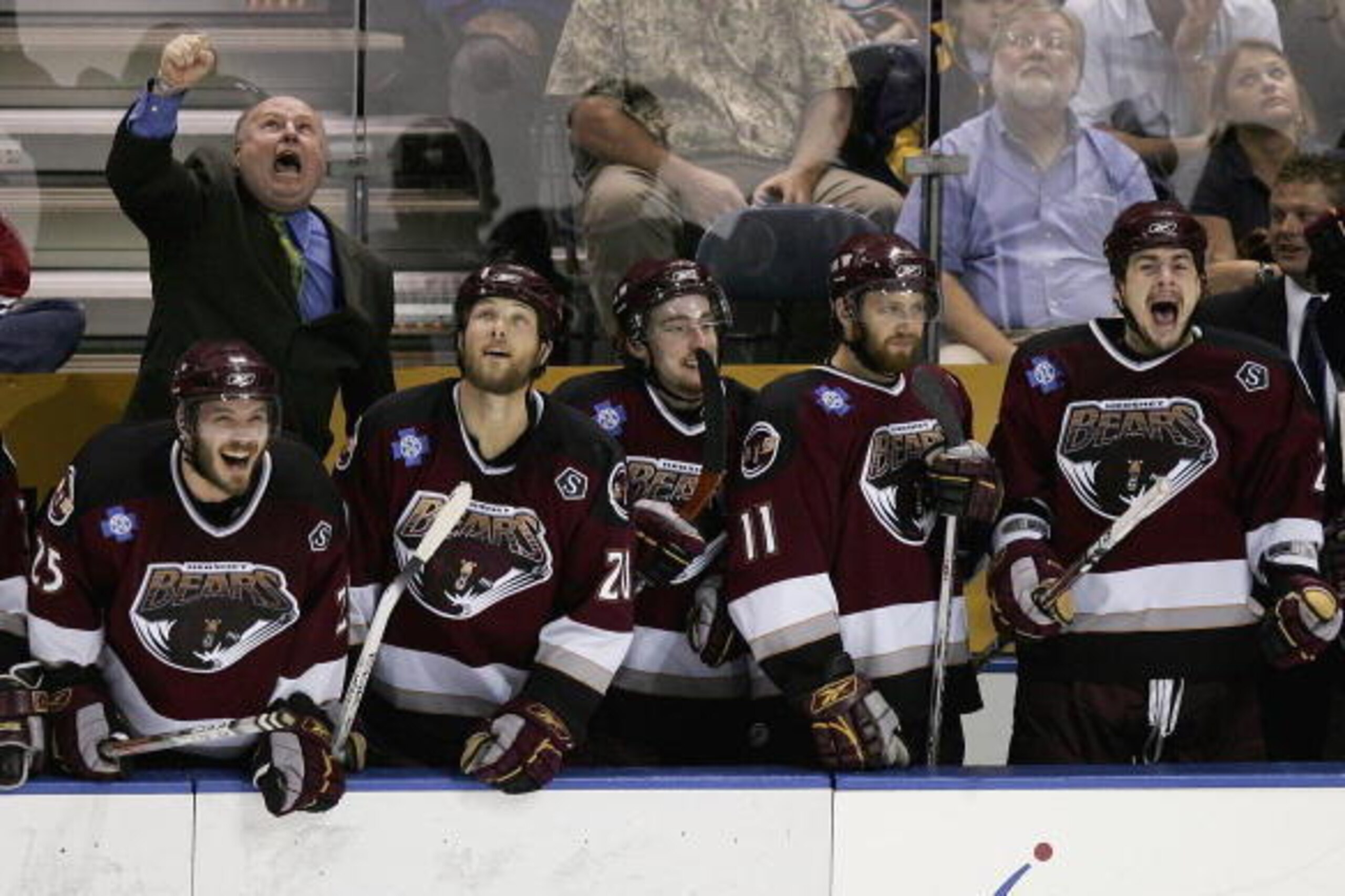 MILWAUKEE - JUNE 15:  Head coach Bruce Boudreau (L), Kris Beech #25, Dave Steckel #20 and Eric Fehr #11 of the Hershey Bears celebrate winning the Calder Cup after defeating the Milwaukee Admirals 5-1 in game six of the AHL Calder Cup Finals on June 15, 2