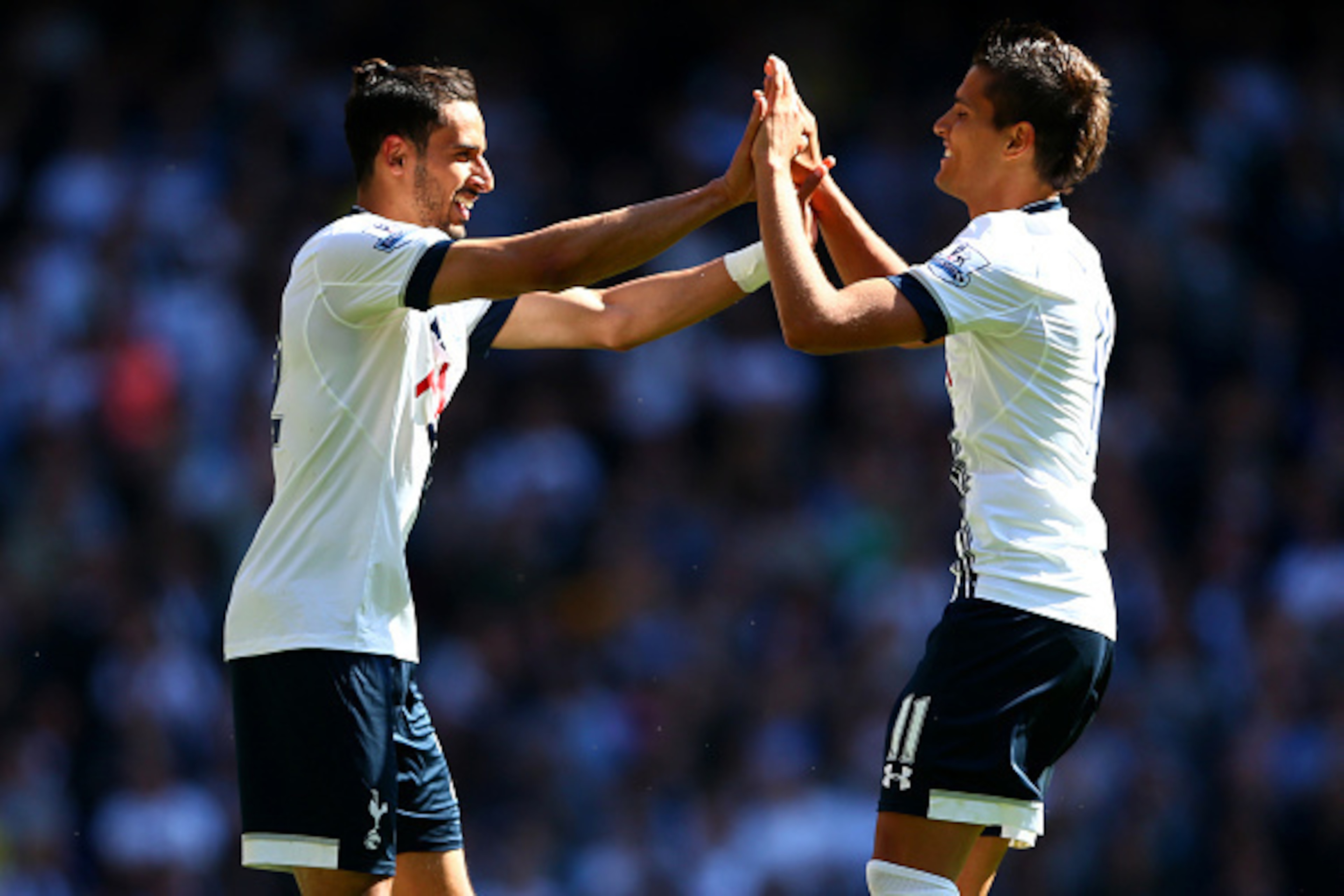 LONDON, ENGLAND - MAY 16: Nacer Chadli (L) of Spurs celebrates scoring his team's first goal with his team mate Erik Lamela during the Barclays Premier League match between  Tottenham Hotspur and Hull City at White Hart Lane on May 16, 2015 in London, Eng