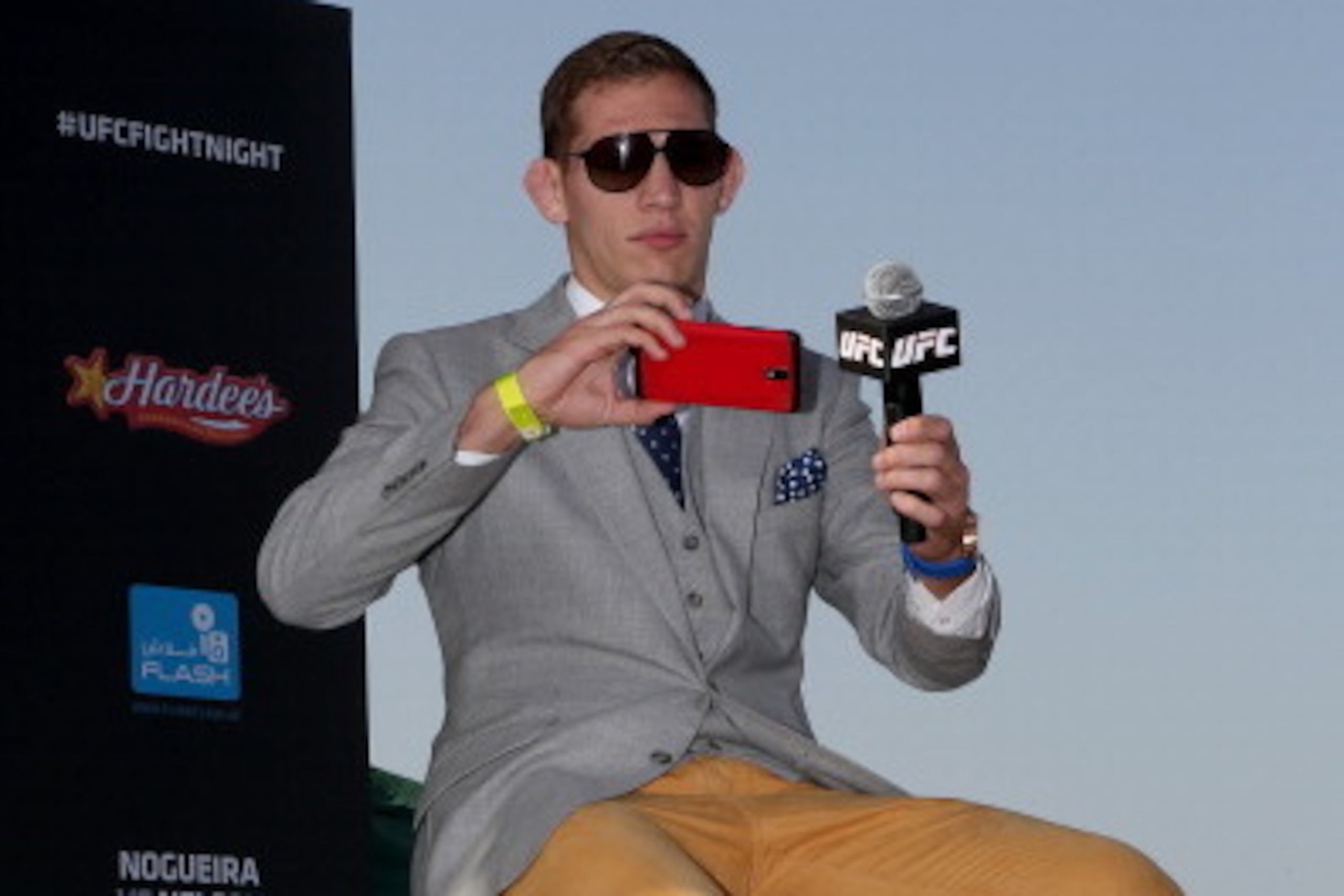 ABU DHABI, UNITED ARAB EMIRATES - APRIL 10:  UFC fighter Luke Barnatt takes a picture of the crowd as he answers questions during a Q&A after the weighs-in for UFC Fight Night 39 on April 10, 2014 in Abu Dhabi, United Arab Emirates. UFC Fight Night 39 wil