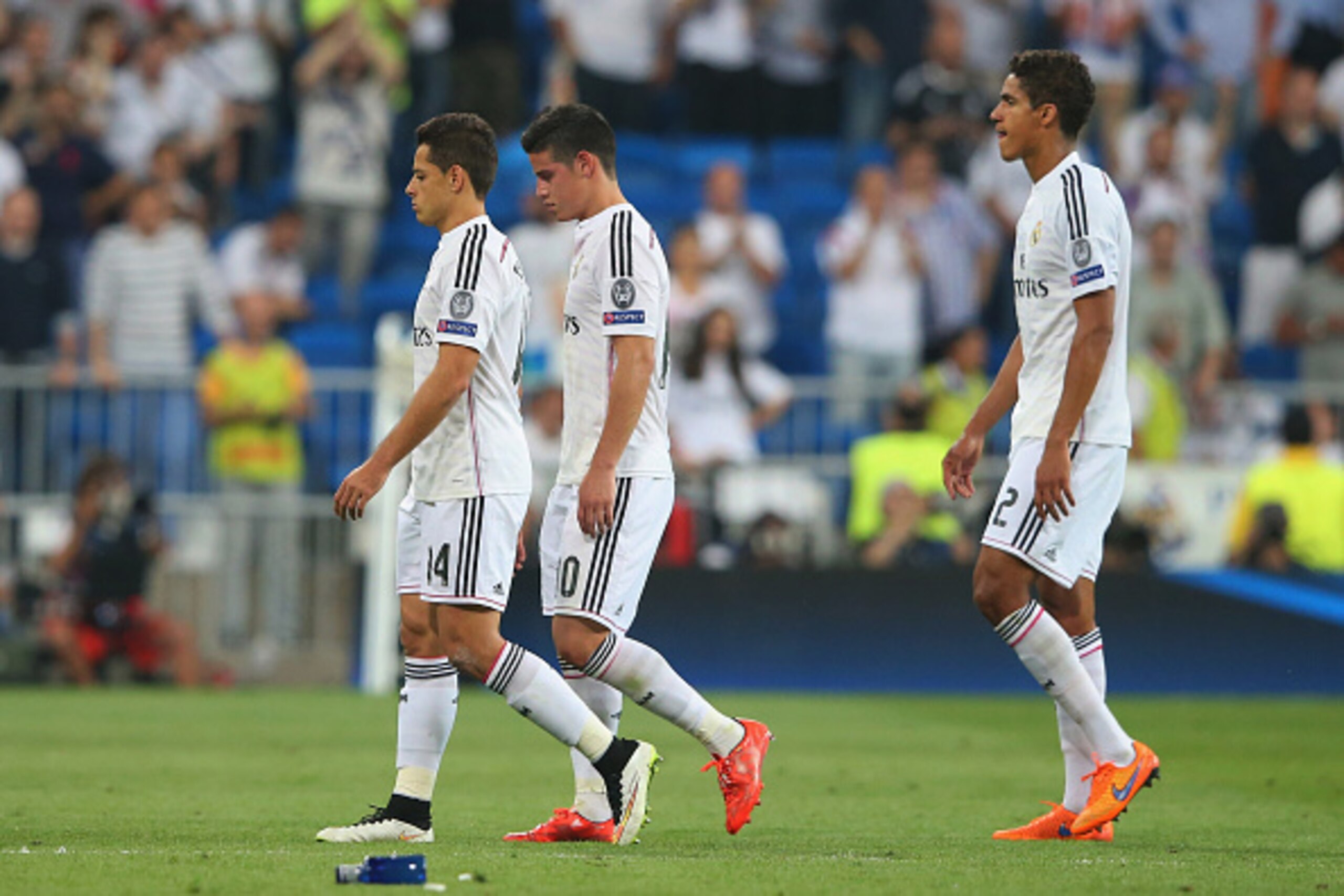 MADRID, SPAIN - MAY 13: (L-R) Dejected Real Madrid teammates Javier Hernandez, James Rodriguez and Raphael Varane walk off the pitch following their team's exit from the competition during the UEFA Champions League Semi Final, second leg match between Re MADRID, SPAIN - MAY 13: (L-R) Dejected Real Madrid teammates Javier Hernandez, James Rodriguez and Raphael Varane walk off the pitch following their team's exit from the competition during the UEFA Champions League Semi Final, second leg match between Re