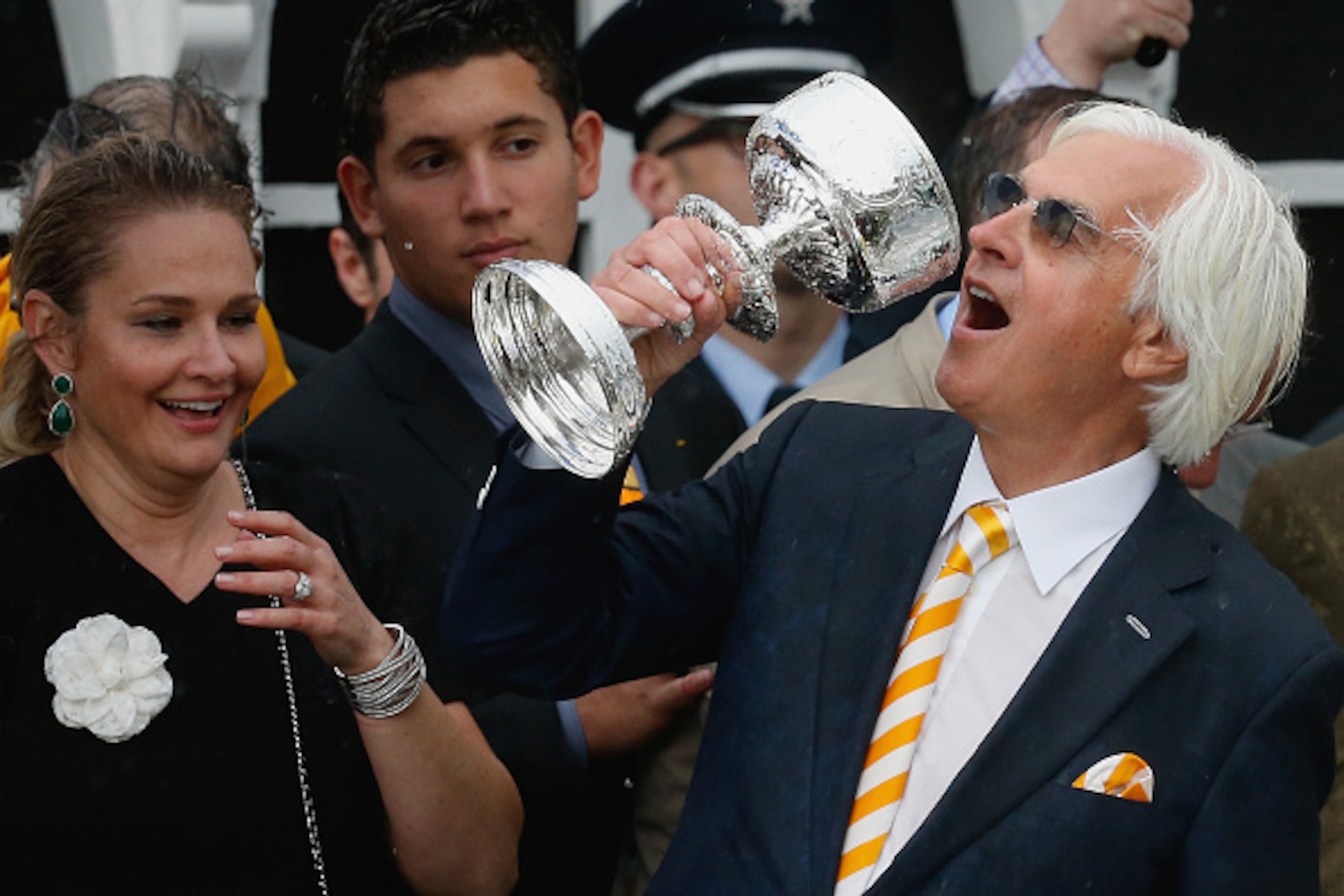 BALTIMORE, MD - MAY 16: Trainer Bob Baffert jokes with the trophy in the winners circle after his horse American Pharoah won the 140th running of the Preakness Stakes at Pimlico Race Course on May 16, 2015 in Baltimore, Maryland.  (Photo by Rob Carr/Getty