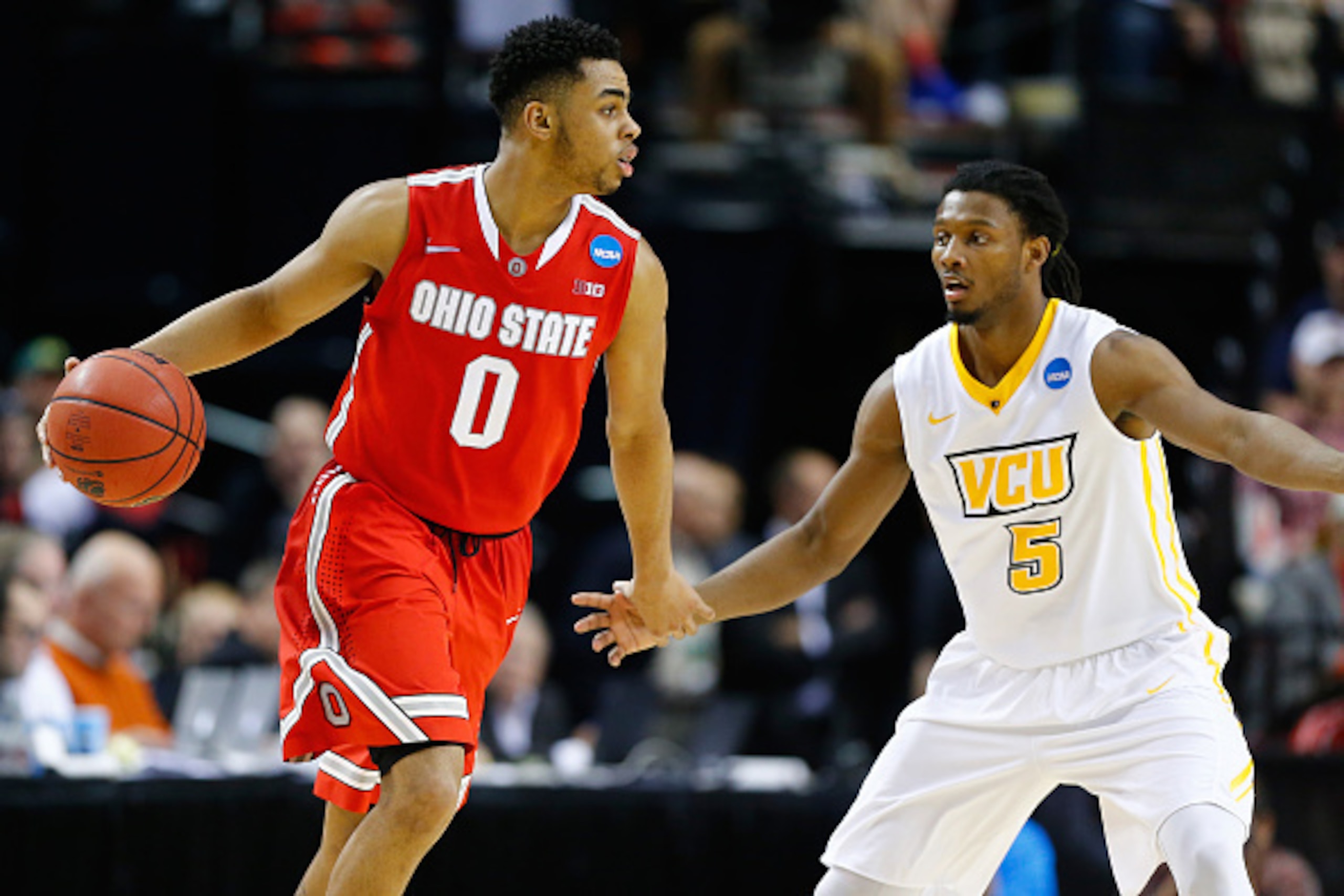 PORTLAND, OR - MARCH 19: D'Angelo Russell #0 of the Ohio State Buckeyes dribbles in front of Doug Brooks #5 of the Virginia Commonwealth Rams in the second half during the second round of the 2015 NCAA Men's Basketball Tournament at Moda Center on March 1