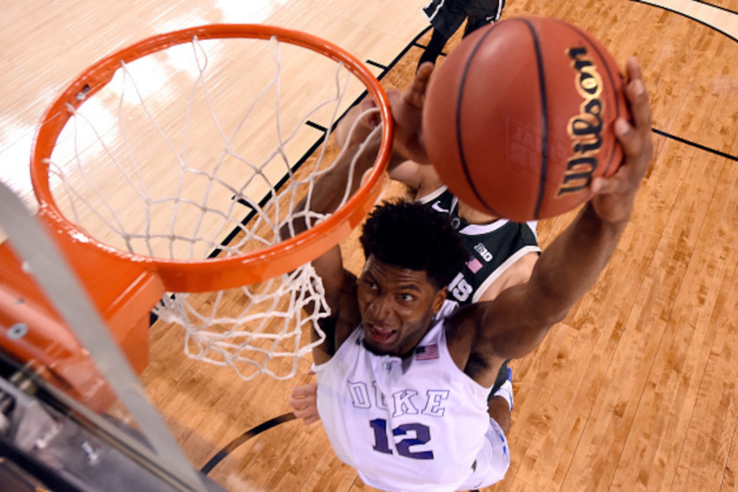 INDIANAPOLIS, IN - APRIL 04: Justise Winslow #12 of the Duke Blue Devils goes up for a dunk in the second half against the Michigan State Spartans during the NCAA Men's Final Four Semifinal at Lucas Oil Stadium on April 4, 2015 in Indianapolis, Indiana.  