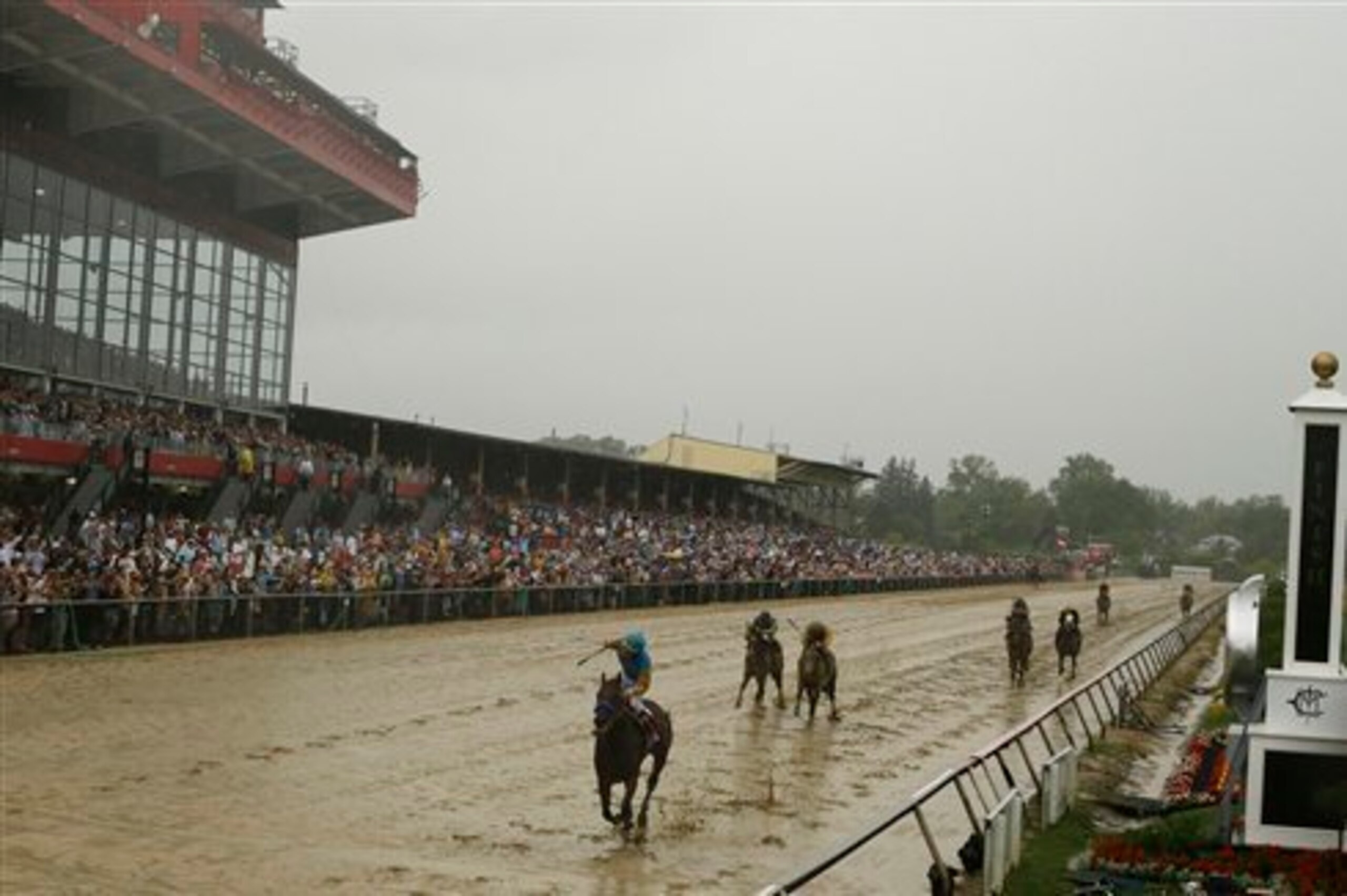 American Pharoah won by seven lengths on a rain-soaked track.