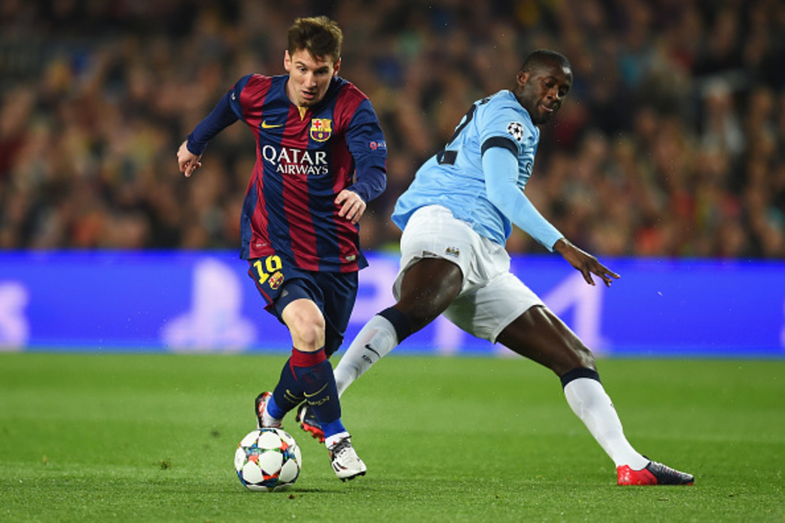 BARCELONA, SPAIN - MARCH 18: Lionel Messi of Barcelona is challenged by Yaya Toure of Manchester City during the UEFA Champions League Round of 16 second leg match between Barcelona and Manchester City at Camp Nou on March 18, 2015 in Barcelona, Spain.  (