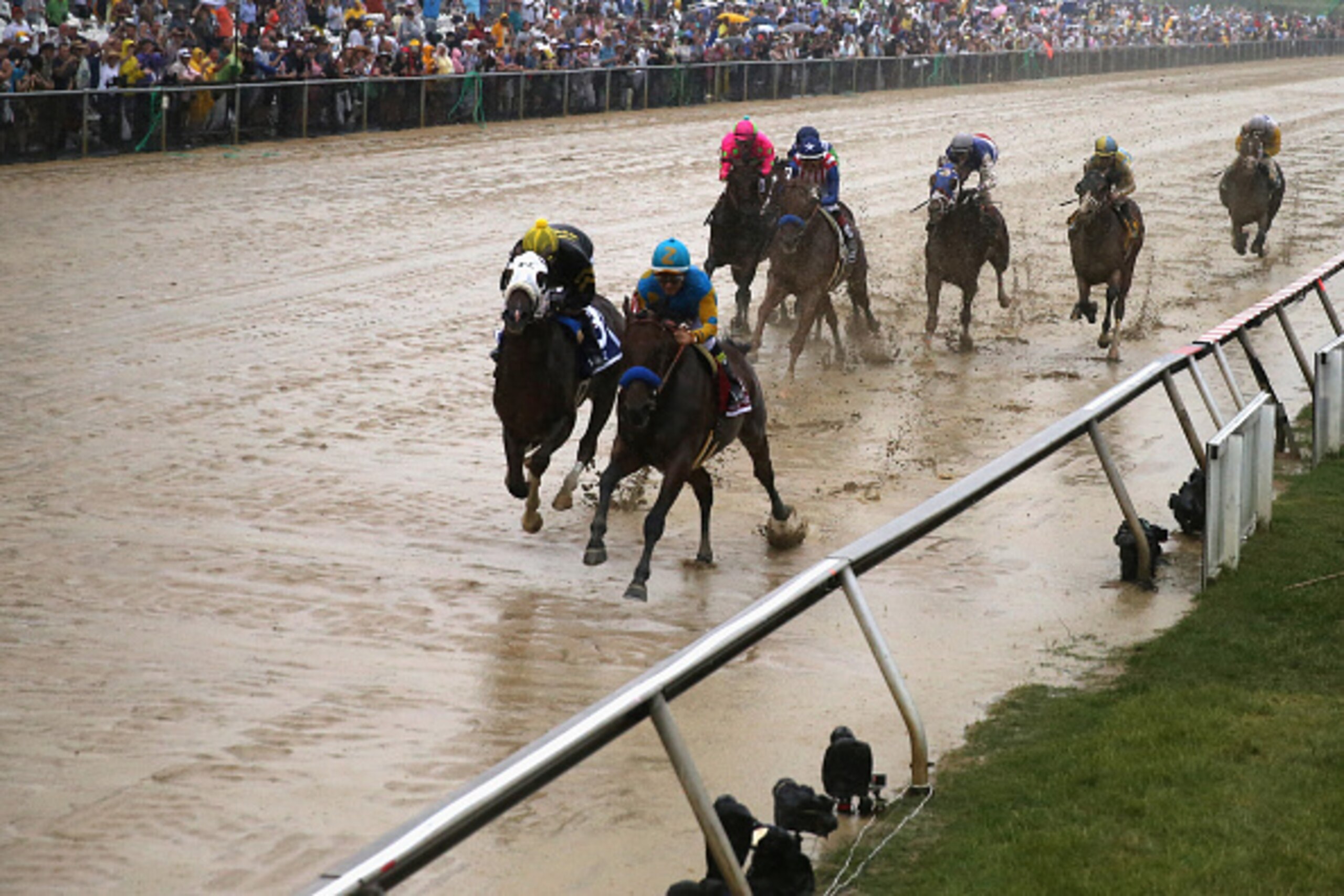 BALTIMORE, MD - MAY 16: American Pharoah #1 ridden by Victor Espinoza leads the field into the first turn during the 140th running of the Preakness Stakes at Pimlico Race Course on May 16, 2015 in Baltimore, Maryland.  (Photo by Rob Carr/Getty Images)