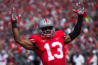 Apr 12, 2014; Columbus, OH, USA; Ohio State scarlet team cornerback Eli Apple (13) celebrates his squad's first-quarter touchdown during the Ohio State Buckeyes spring game at Ohio Stadium. The scarlet team won the game 17-7. Mandatory Credit: Greg Bartra