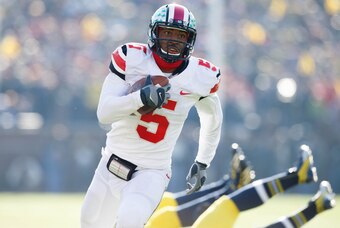 Nov 30, 2013; Ann Arbor, MI, USA; Ohio State Buckeyes quarterback Braxton Miller (5) runs the ball for a touchdown in the second quarter against the Michigan Wolverines at Michigan Stadium. Mandatory Credit: Rick Osentoski-USA TODAY Sports