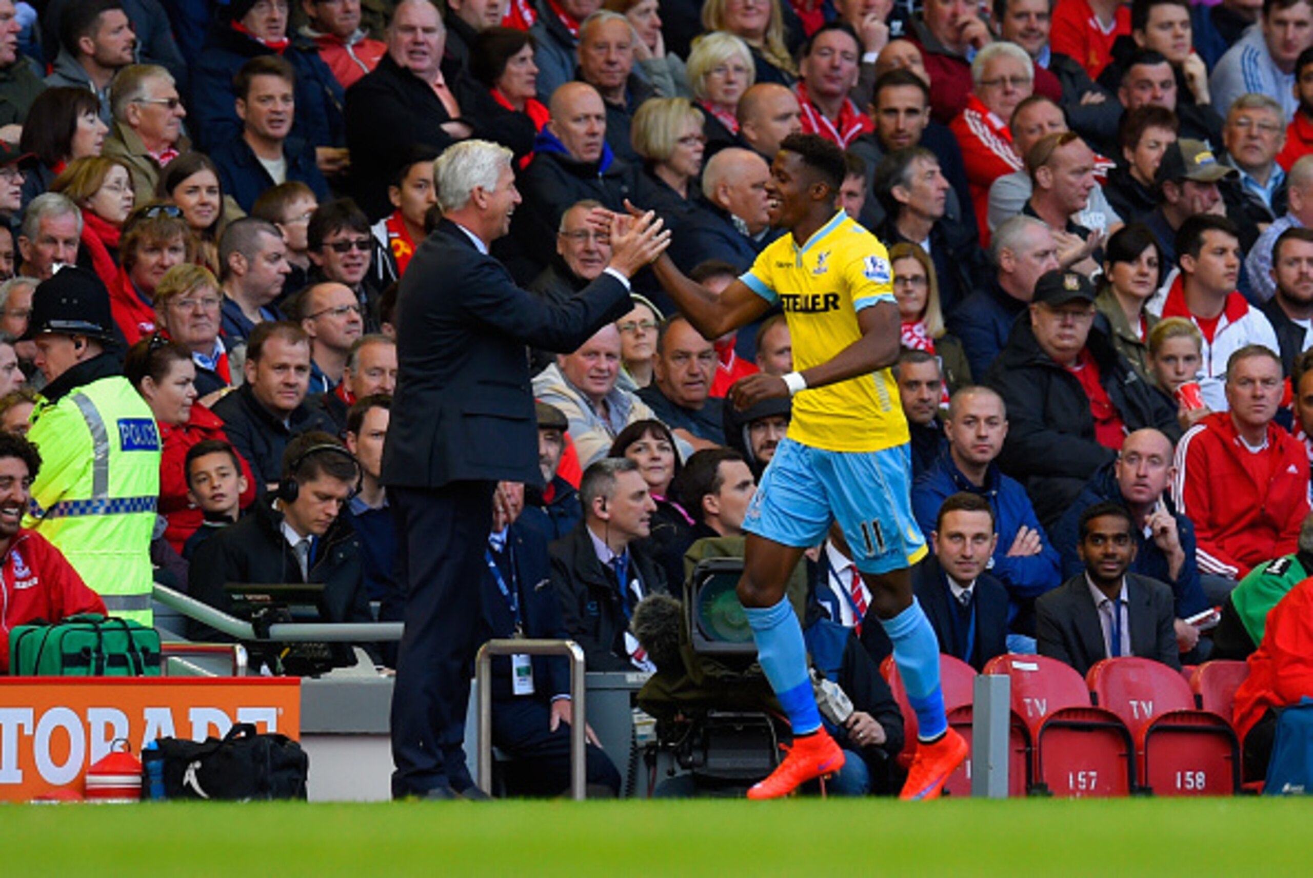 LIVERPOOL, ENGLAND - MAY 16:  Manager Alan Pardew of Crystal Palace congratulates Wilfried Zaha of Crystal Palace on scoring their second goal during the Barclays Premier League match between Liverpool and Crystal Palace at Anfield on May 16, 2015 in Live