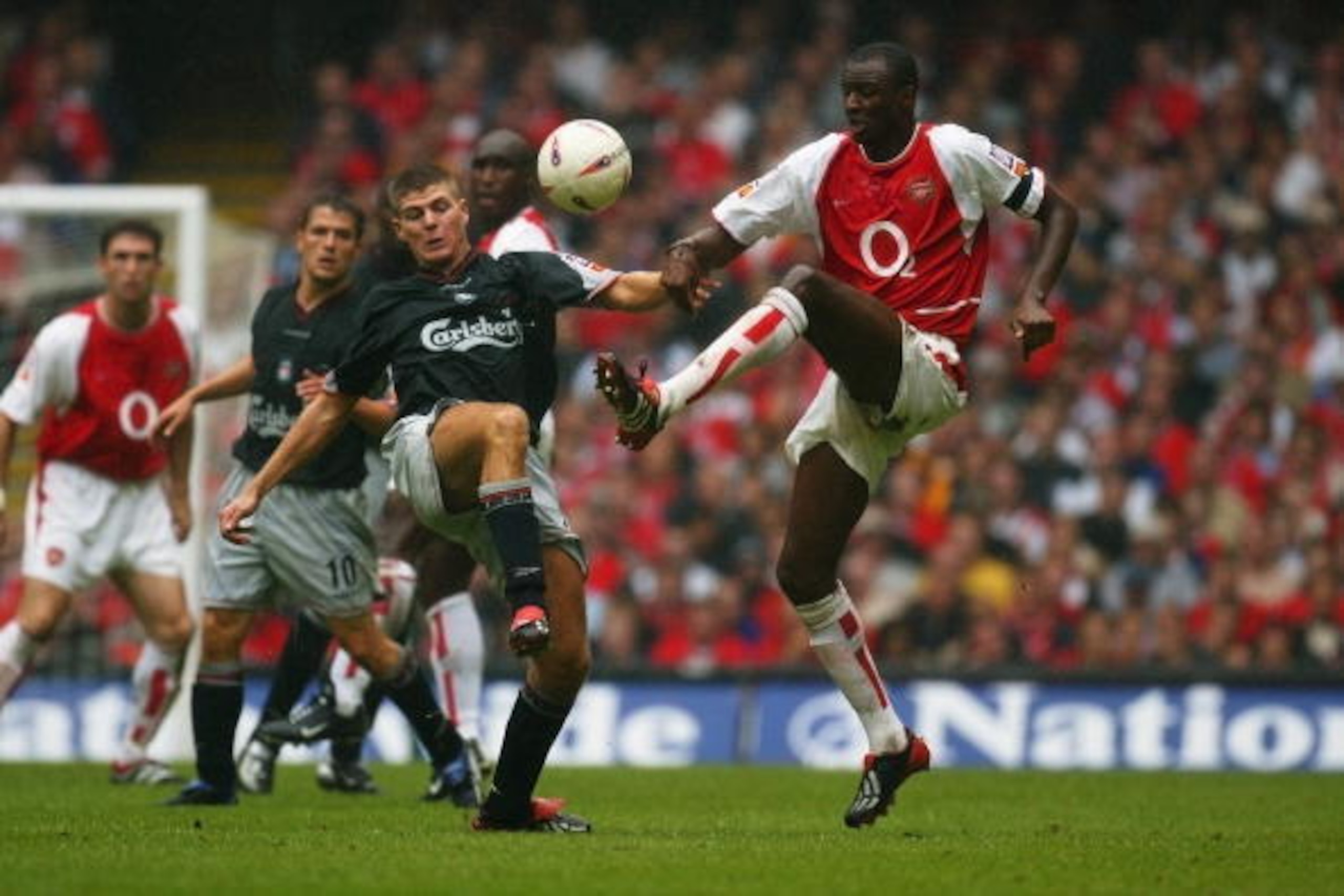 CARDIFF - AUGUST 11:  Steven Gerrard of Liverpool and Patrick Vieira of Arsenal challenge for the ball during the FA Community Shield between Arsenal and Liverpool at the Millennium Stadium in Cardiff, Wales on August 11, 2002. (Photo by Mike Hewitt/Getty