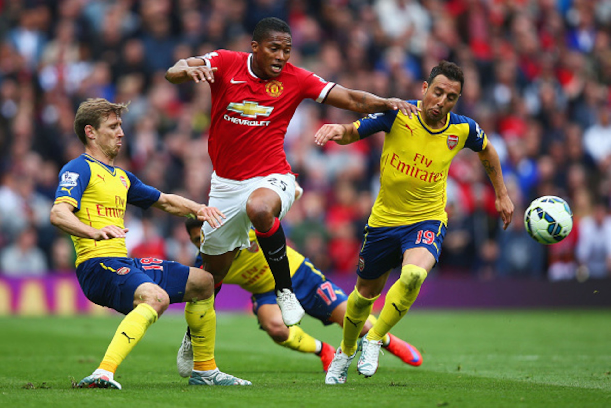 MANCHESTER, ENGLAND - MAY 17:  Luis Antonio Valencia of Manchester United takes on Nacho Monreal, Alexis Sanchez and Santi Cazorla of Arsenal during the Barclays Premier League match between Manchester United and Arsenal at Old Trafford on May 17, 2015 in