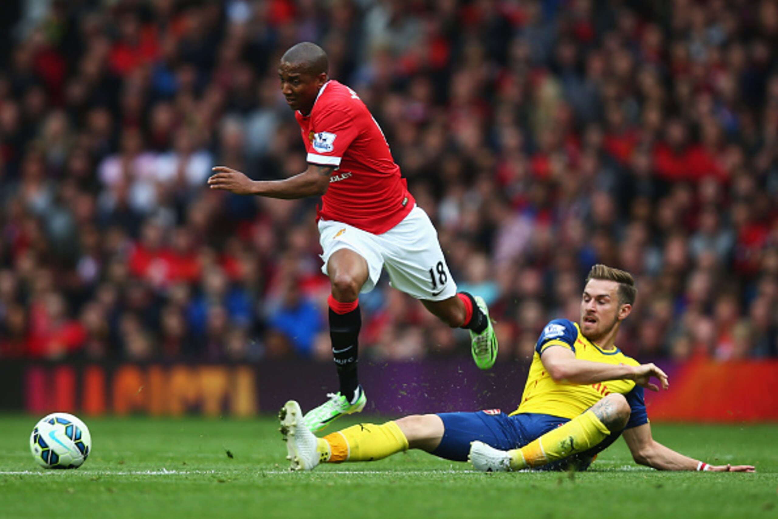MANCHESTER, ENGLAND - MAY 17: Ashley Young of Manchester United evades Aaron Ramsey of Arsenal during the Barclays Premier League match between Manchester United and Arsenal at Old Trafford on May 17, 2015 in Manchester, England. (Photo by Clive Rose/Ge MANCHESTER, ENGLAND - MAY 17: Ashley Young of Manchester United evades Aaron Ramsey of Arsenal during the Barclays Premier League match between Manchester United and Arsenal at Old Trafford on May 17, 2015 in Manchester, England. (Photo by Clive Rose/Ge