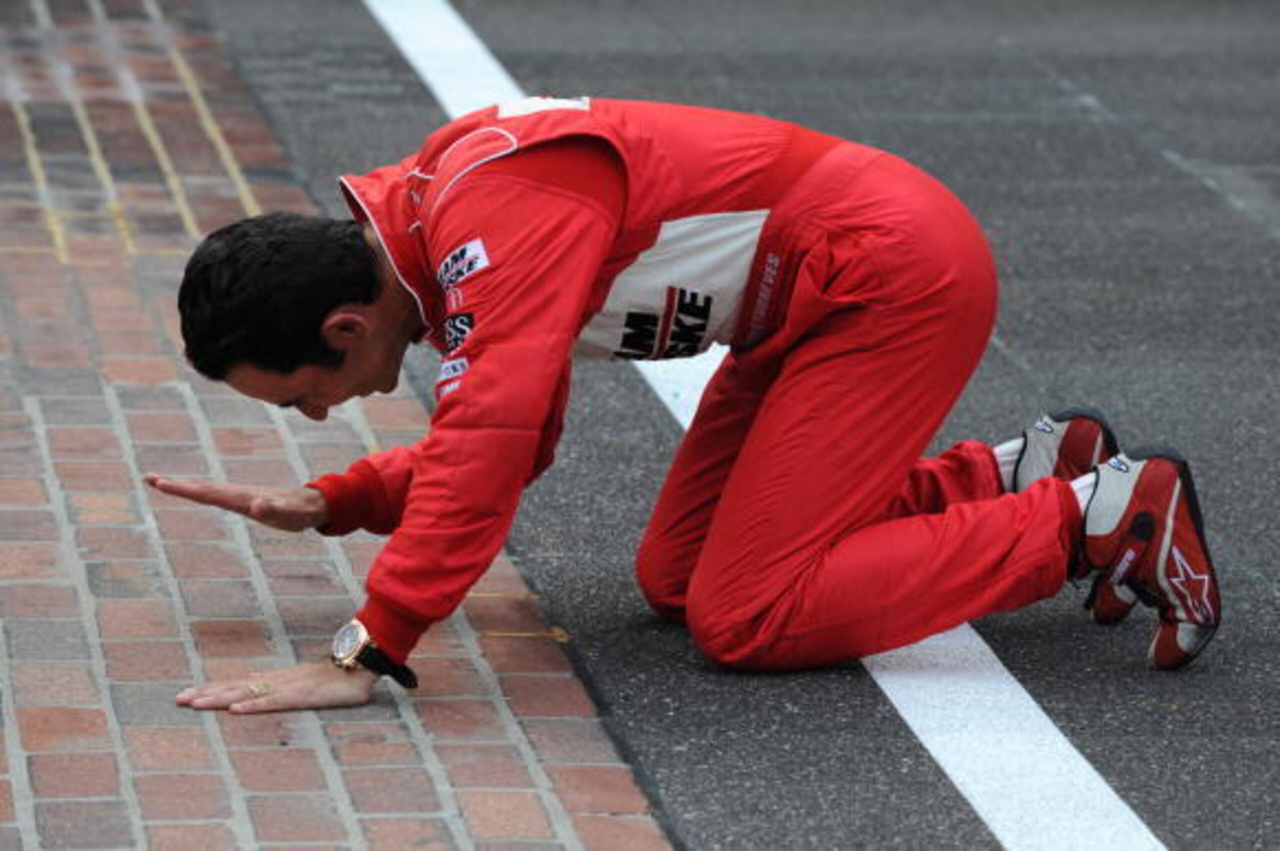 INDIANAPOLIS - MAY 24: Helio Castroneves driver of the #3 Team Penske Dallara Honda kisses the yard of bricks on the front stretch after winning the IRL IndyCar Series 93rd running of the Indianapolis 500 at the Indianapolis Motor Speedway on May 24, 200 INDIANAPOLIS - MAY 24: Helio Castroneves driver of the #3 Team Penske Dallara Honda kisses the yard of bricks on the front stretch after winning the IRL IndyCar Series 93rd running of the Indianapolis 500 at the Indianapolis Motor Speedway on May 24, 200