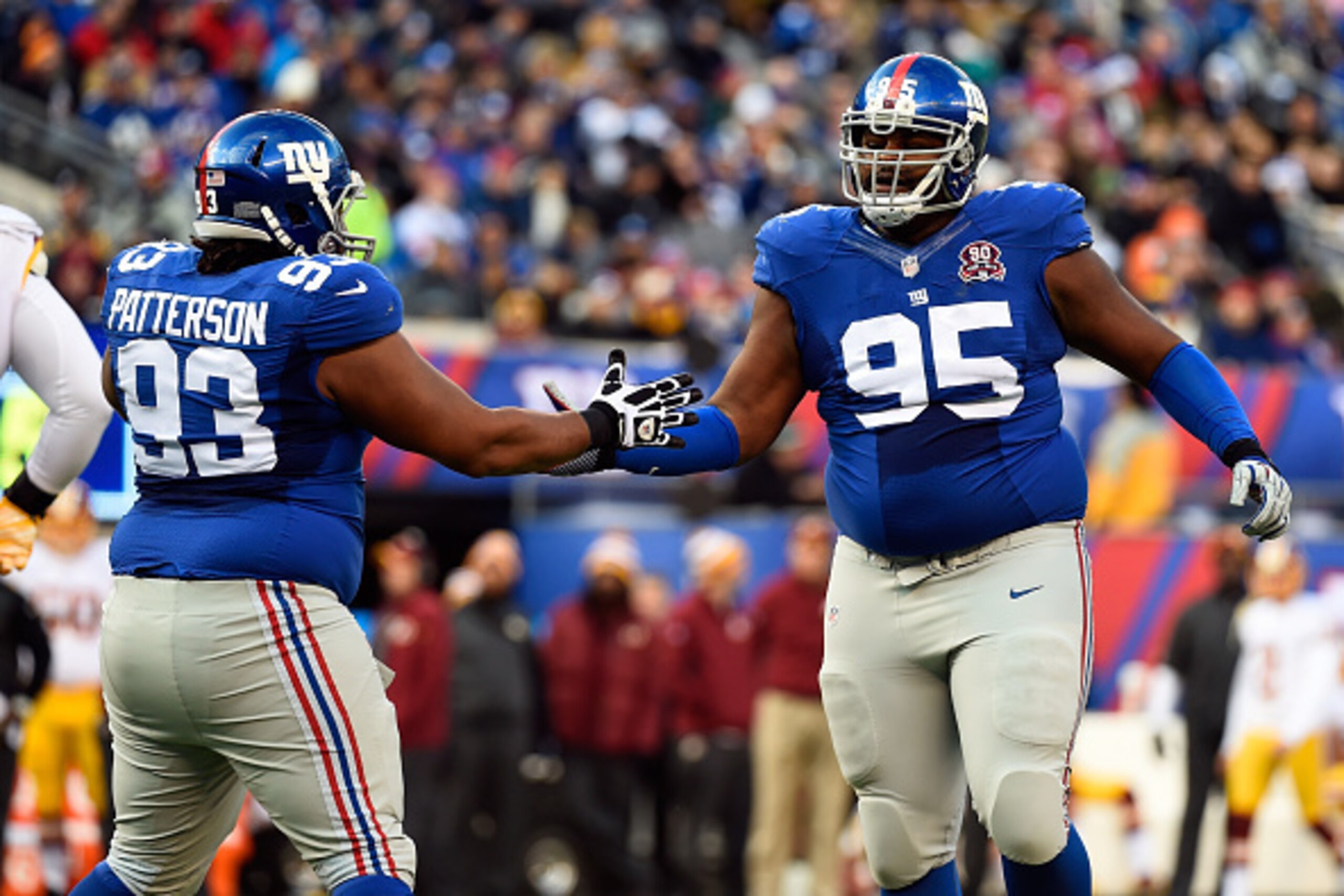EAST RUTHERFORD, NJ - DECEMBER 14:   Mike Patterson #93 and  Johnathan Hankins #95 of the New York Giants celebrate a stop against the Washington Redskins during their game at MetLife Stadium on December 14, 2014 in East Rutherford, New Jersey.  (Photo by